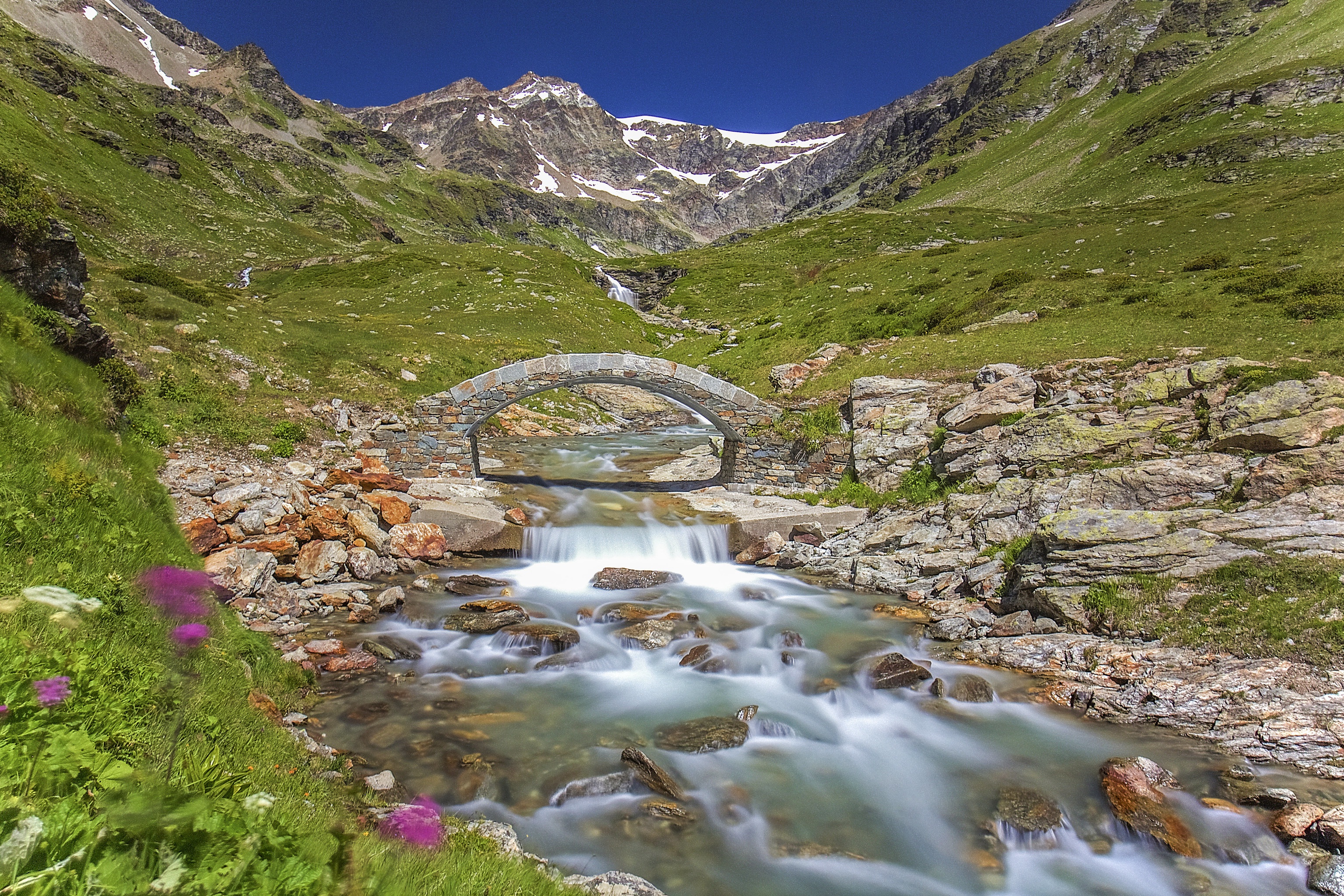 Download mobile wallpaper Bridges, Italy, Mountain, Alps, Bridge, Stream, Man Made for free.