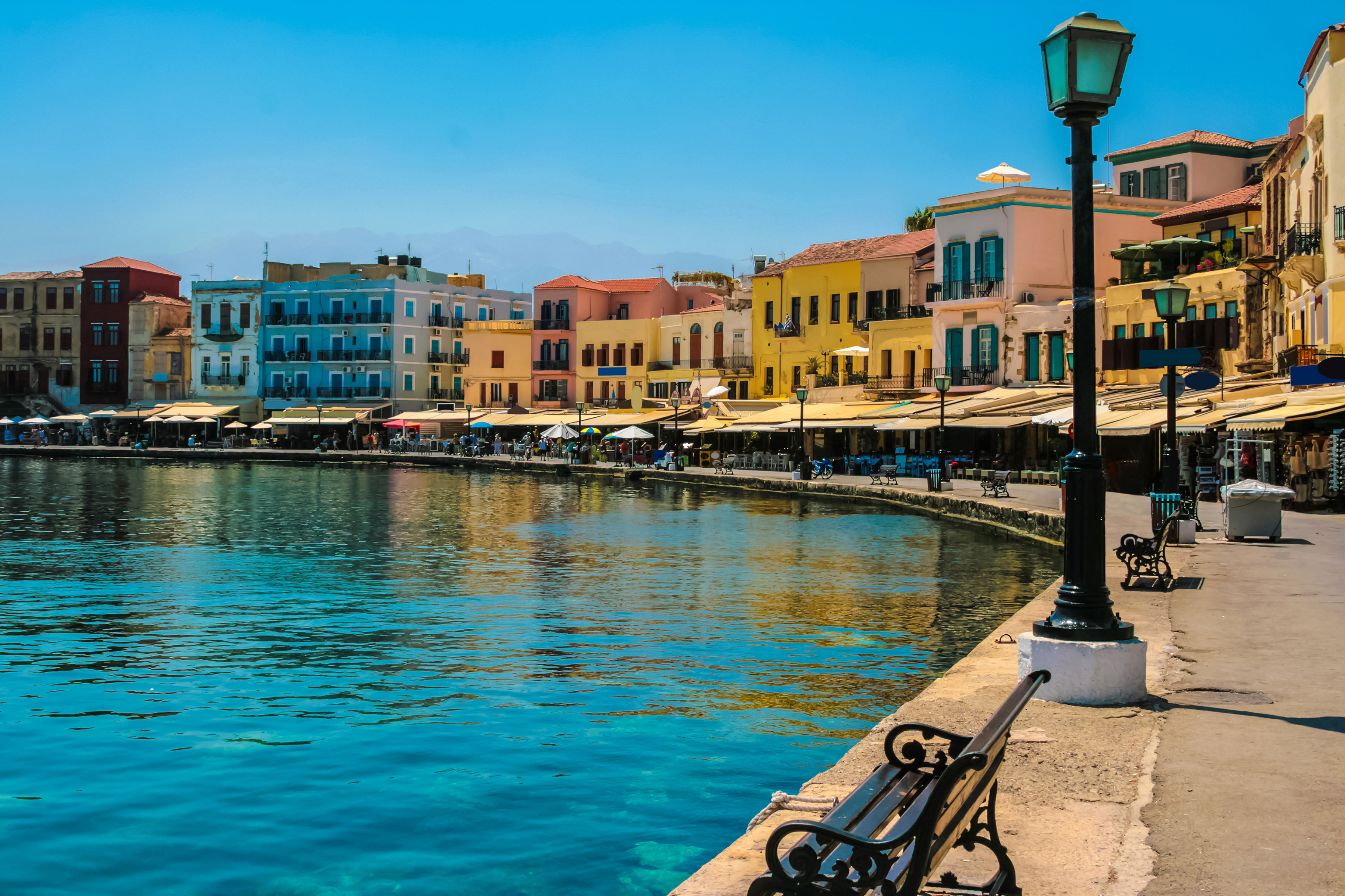 Download mobile wallpaper Coast, House, Colors, Colorful, Bench, Greece, Town, Lamp Post, Man Made, Towns for free.