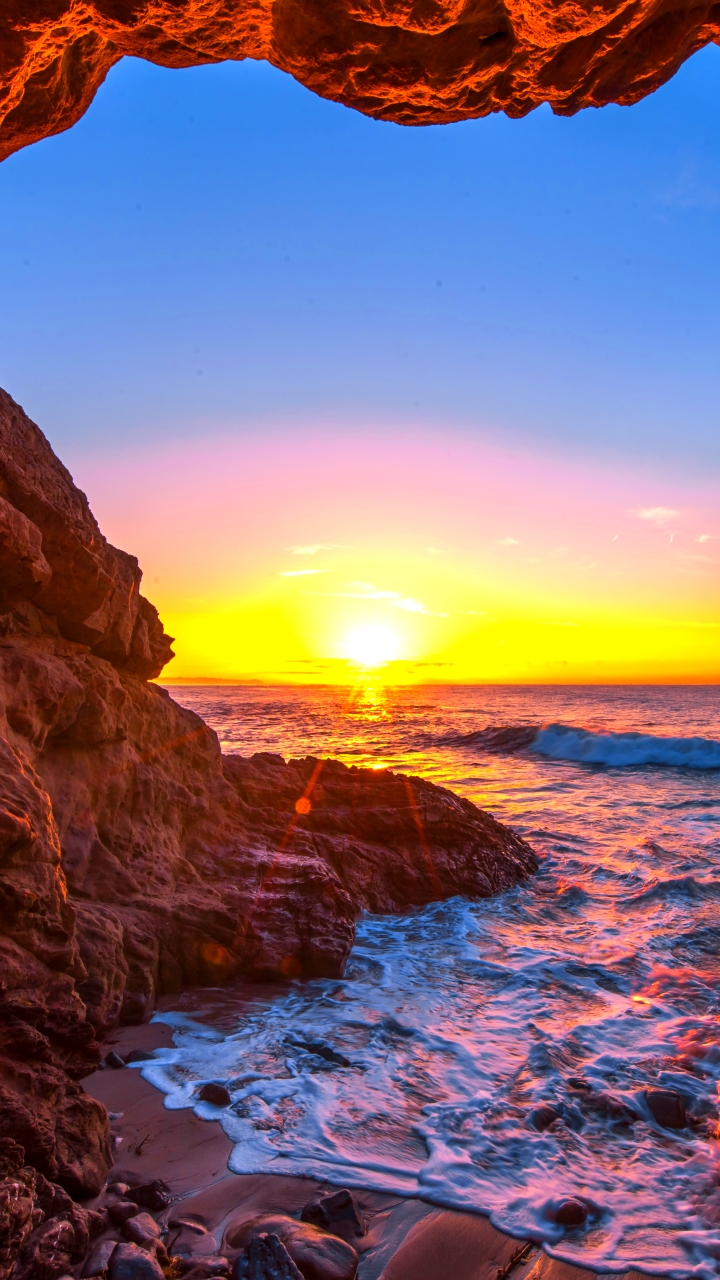 Download mobile wallpaper Sunset, Sea, Sun, Caves, Horizon, Ocean, Earth, Cave for free.