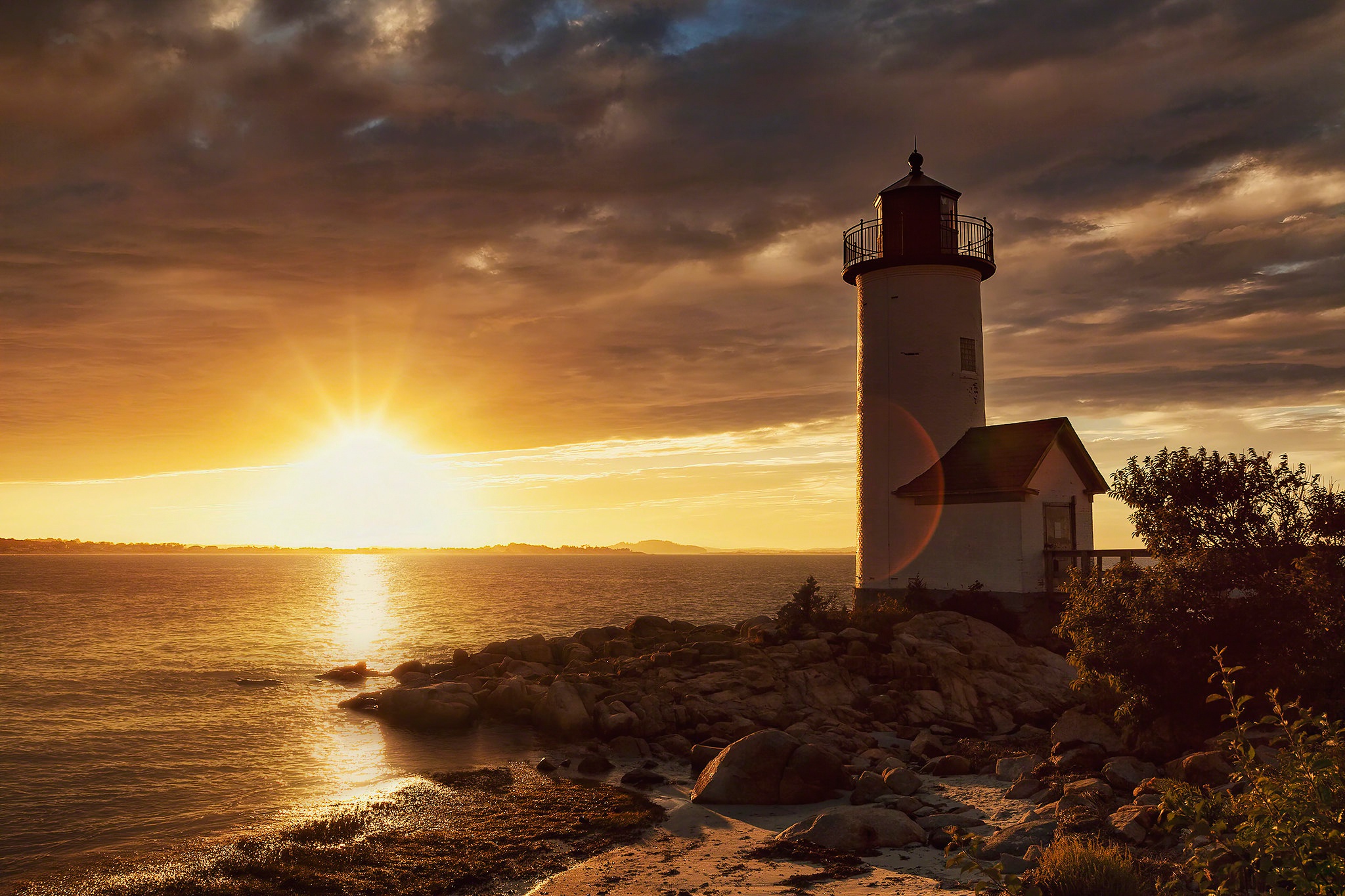 Download mobile wallpaper Sunset, Sun, Building, Horizon, Lighthouse, Man Made for free.