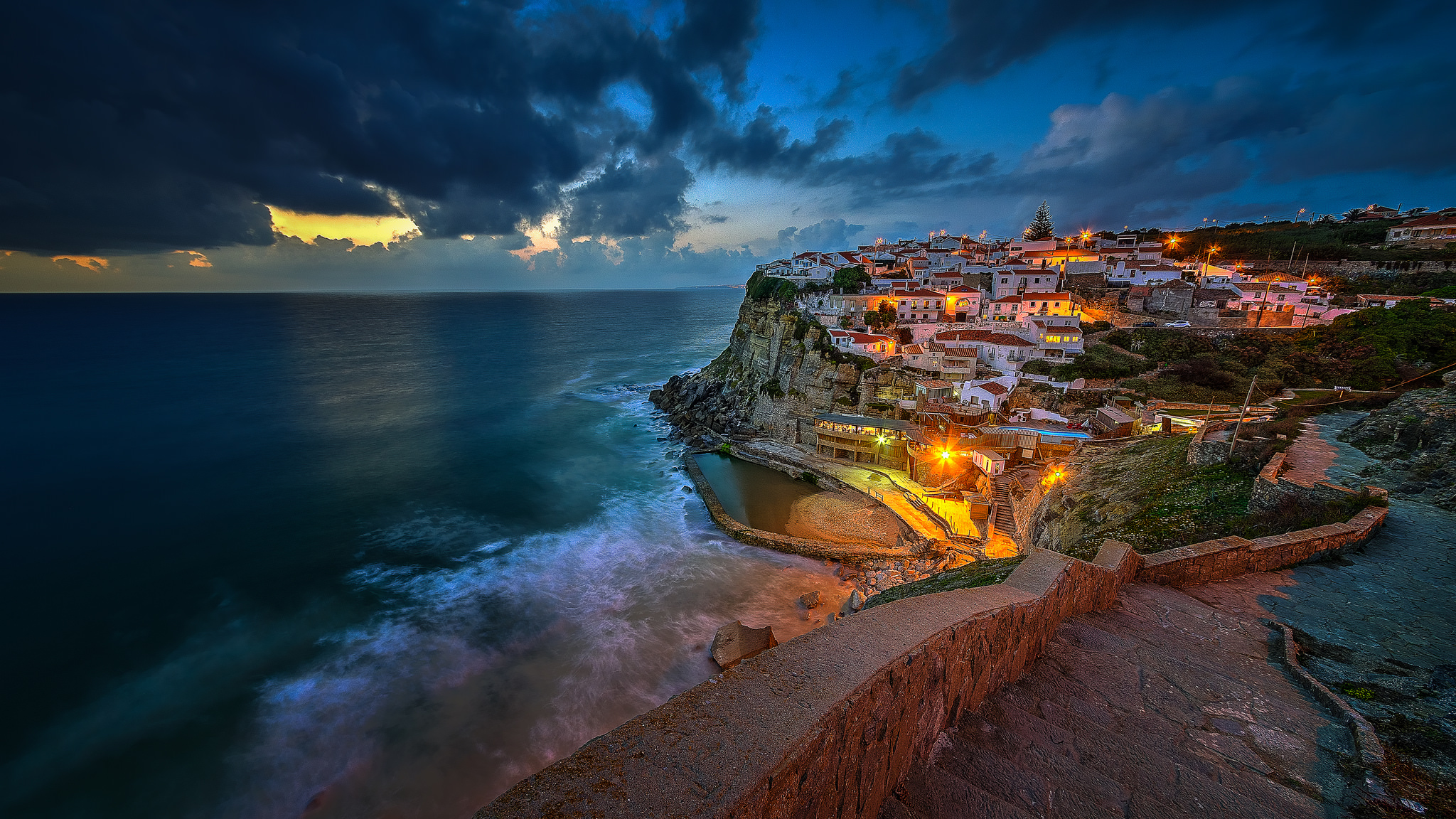 Free download wallpaper Sea, Night, City, Horizon, Coast, Ocean, House, Cliff, Portugal, Town, Man Made, Towns on your PC desktop