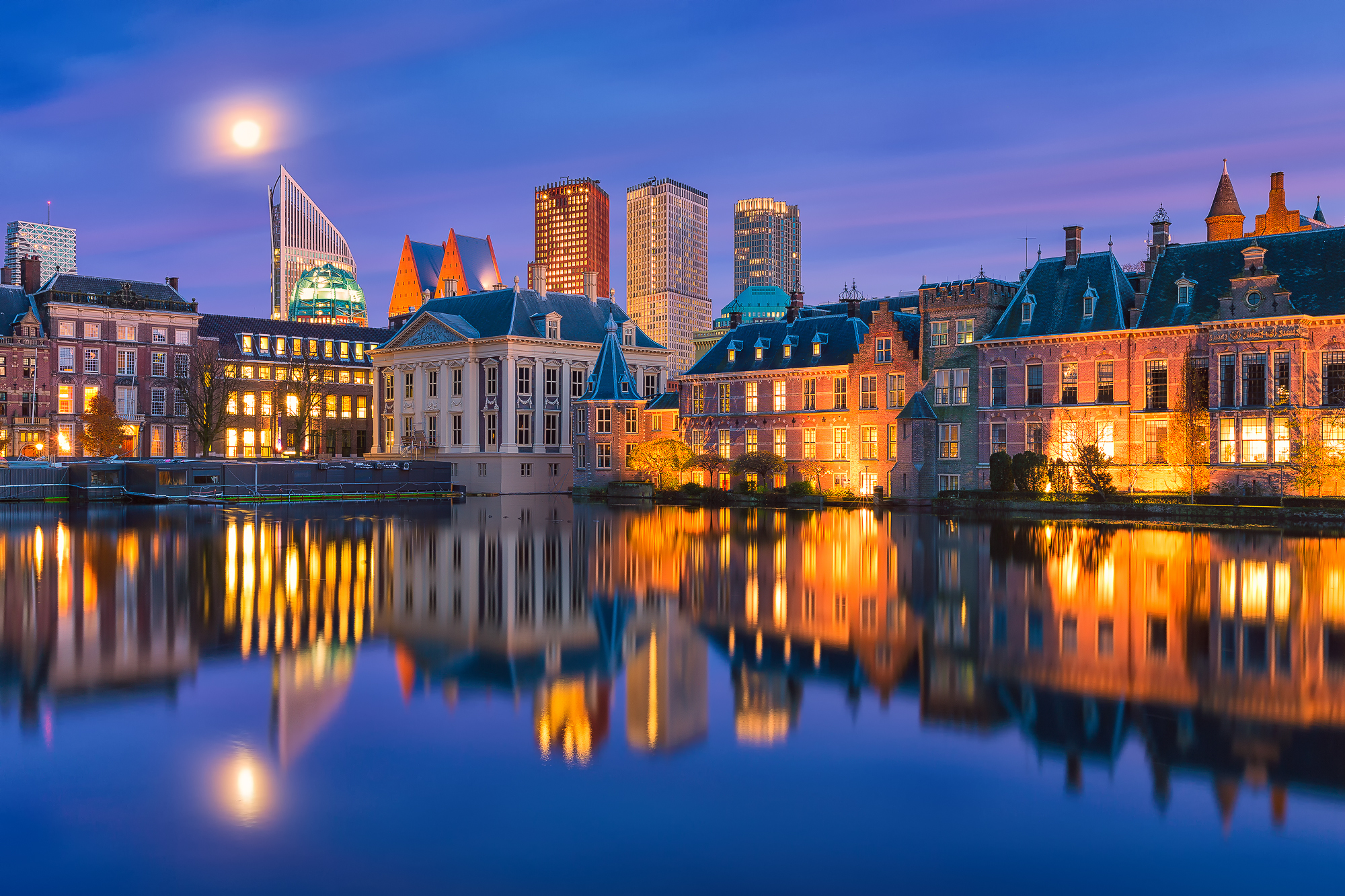 Free download wallpaper Cities, Night, City, Lake, Reflection, Light, Netherlands, Man Made, The Hague on your PC desktop