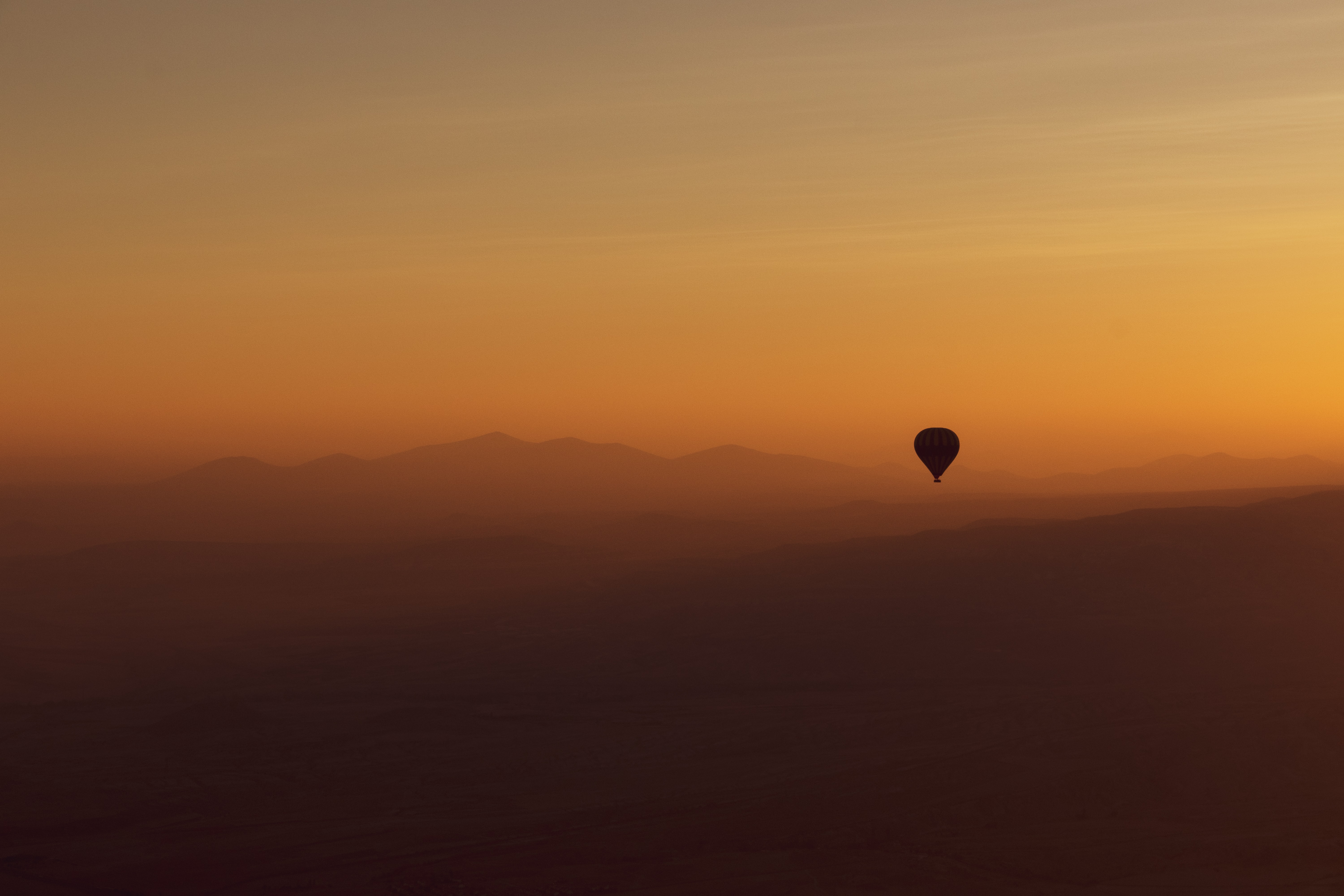 Download mobile wallpaper Balloon, Mountains, Fog, Dusk, Twilight, Nature, Sunset for free.