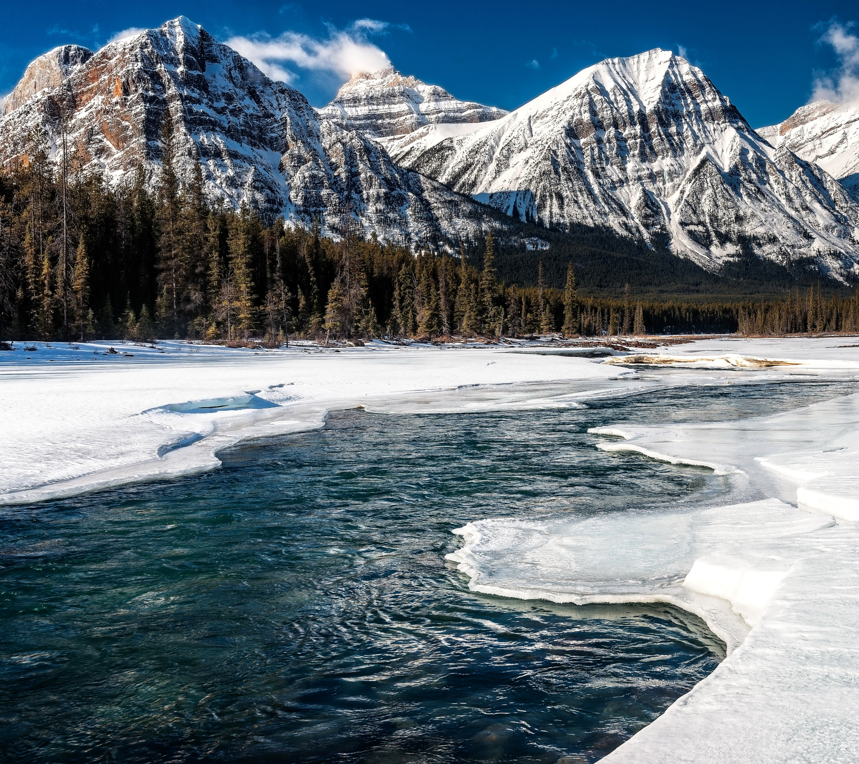 Download mobile wallpaper Landscape, Winter, Nature, Mountains, Ice, Snow, Mountain, Canada, Forest, Earth, River, Alberta for free.