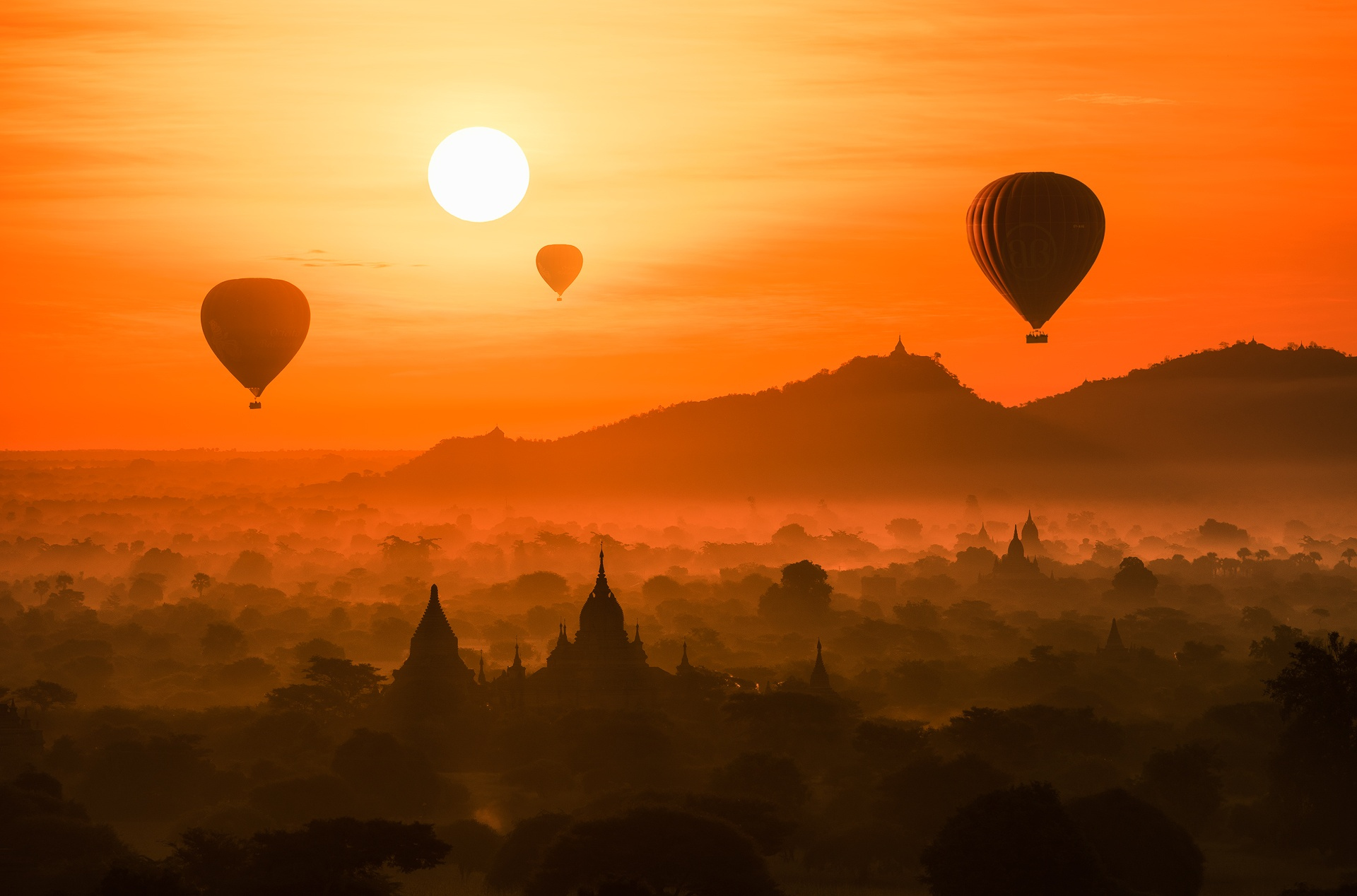 Download mobile wallpaper Landscape, Sunset, Sun, Fog, Photography, Hot Air Balloon for free.