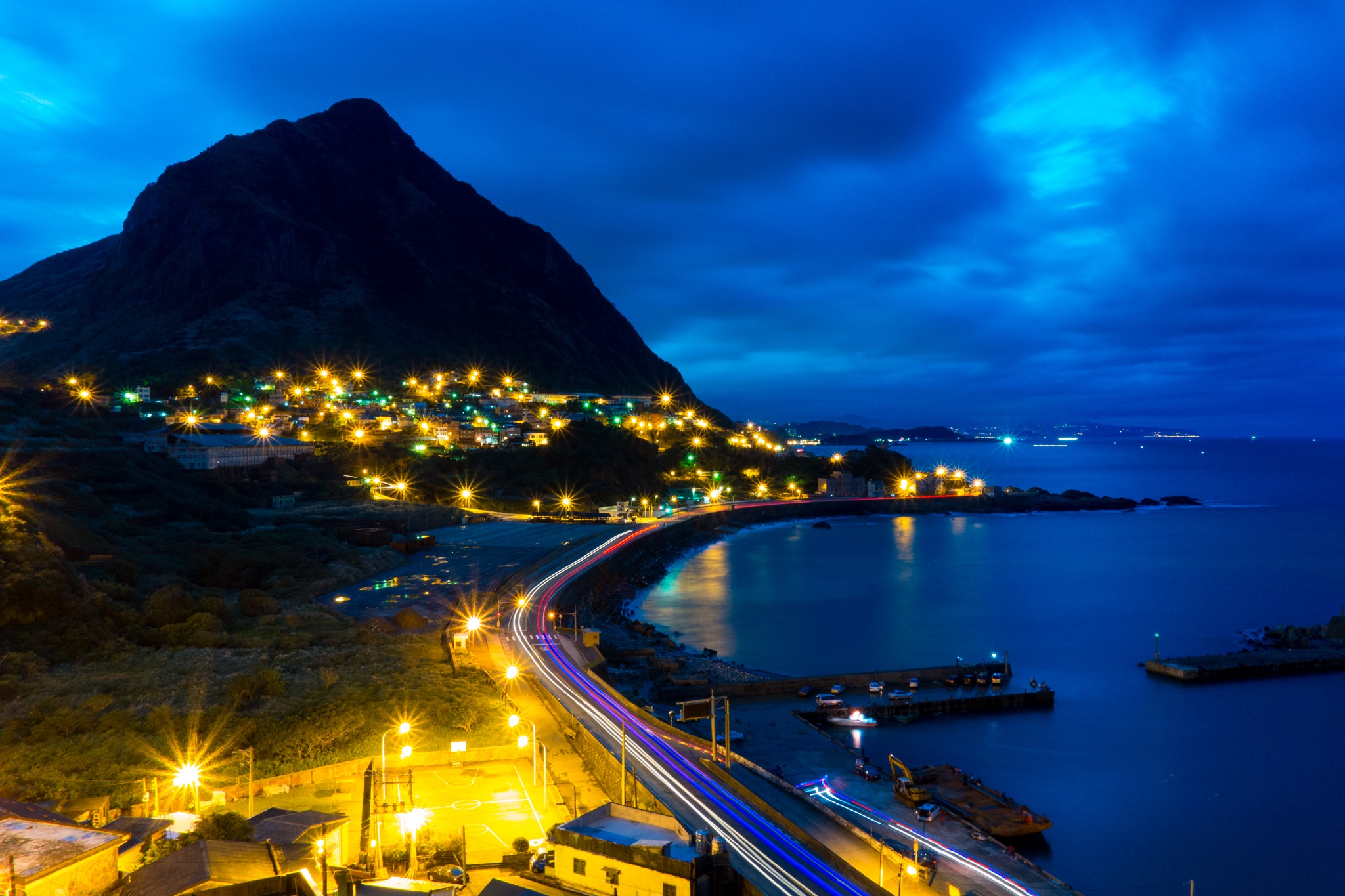 Free download wallpaper Night, Mountain, Light, Road, Ocean, Town, Man Made, Time Lapse, Towns on your PC desktop