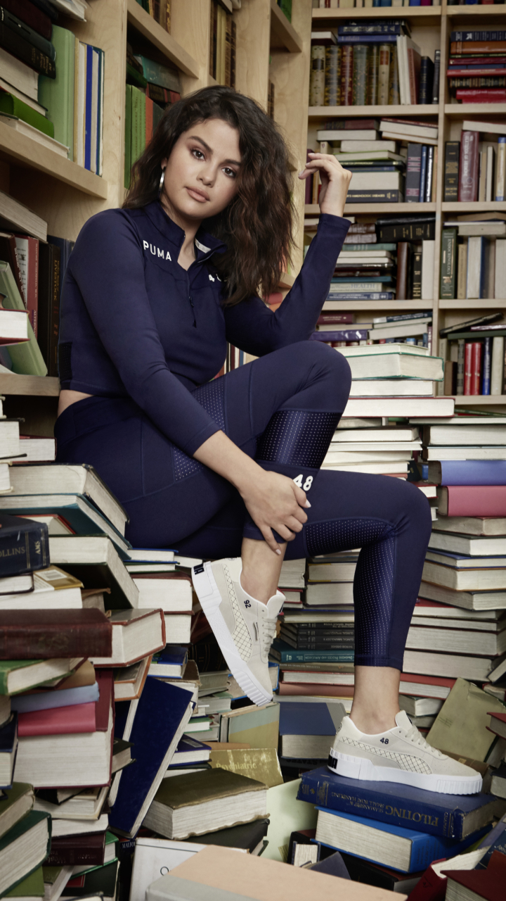 Download mobile wallpaper Music, Selena Gomez, Book, Singer, Brunette, Library, American, Shoe for free.