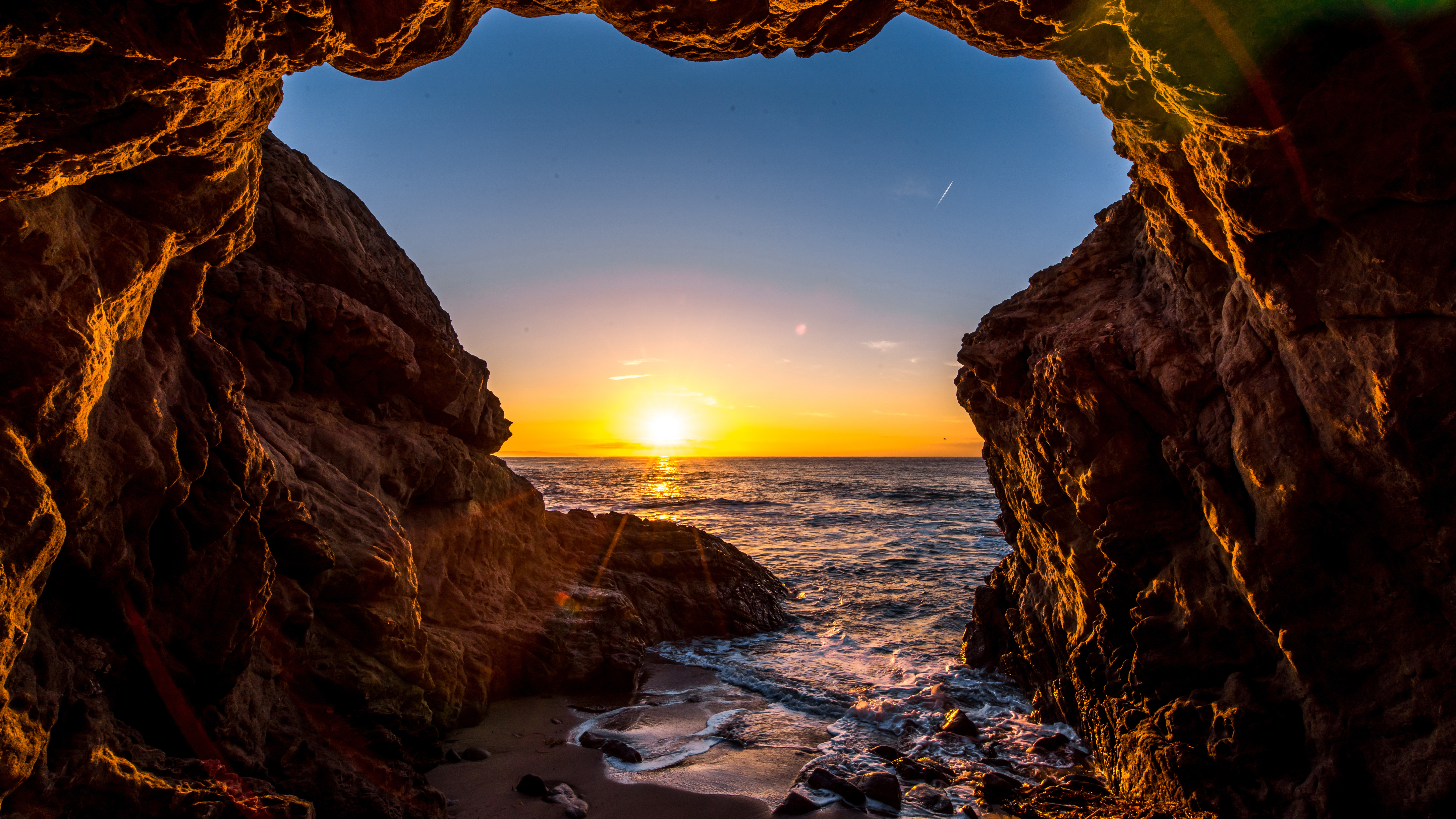 Download mobile wallpaper Sunset, Sea, Beach, Caves, Horizon, Ocean, Earth, Cave for free.
