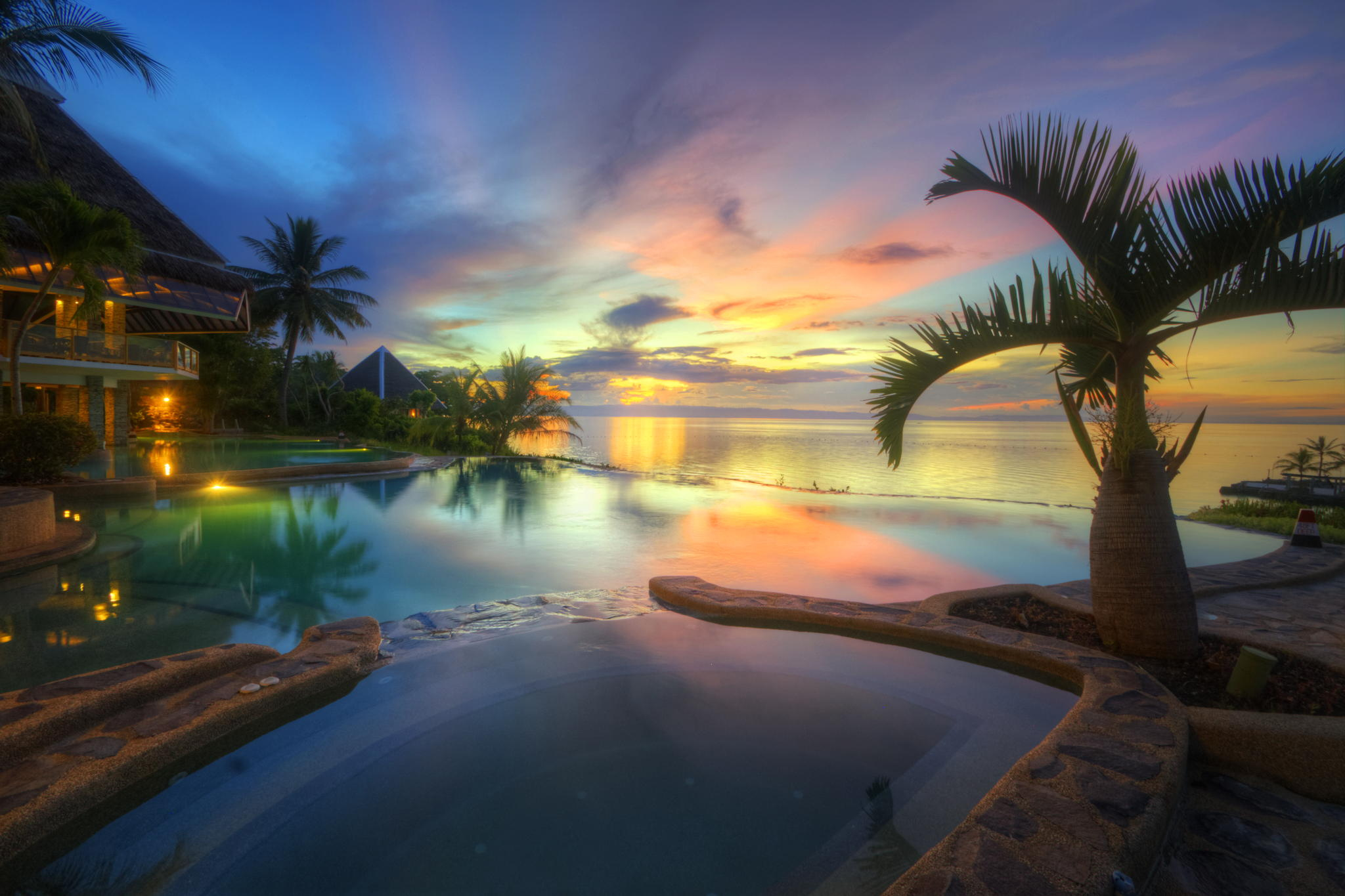 Download mobile wallpaper Sunset, Sea, Horizon, Ocean, Tropical, Resort, Pool, Man Made, Palm Tree for free.