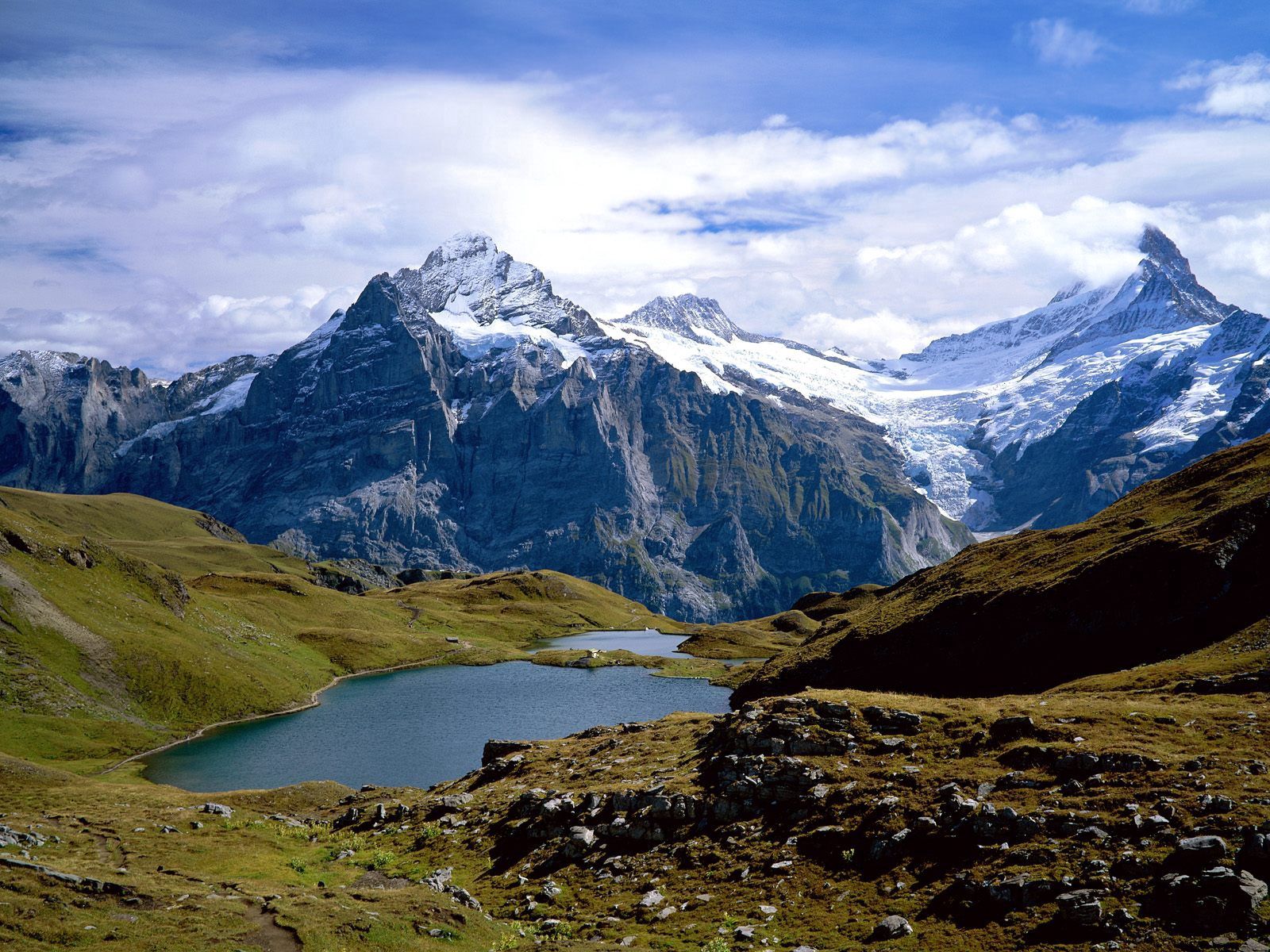 Free download wallpaper Grass, Mountains, Lake, Stones, Nature, Switzerland on your PC desktop