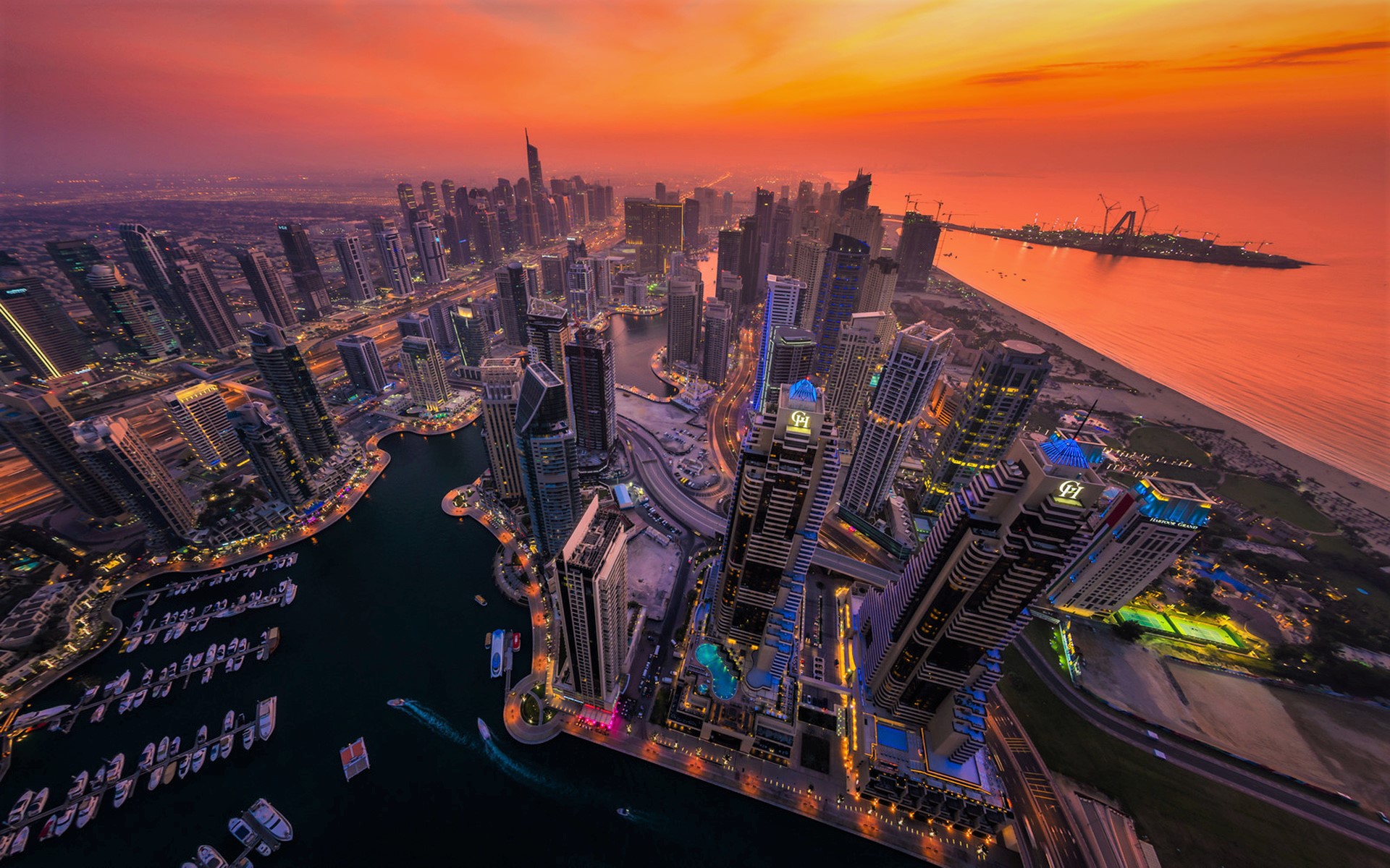 Download mobile wallpaper Cities, Sunset, Sky, City, Skyscraper, Building, Horizon, Light, Dubai, Aerial, Man Made for free.