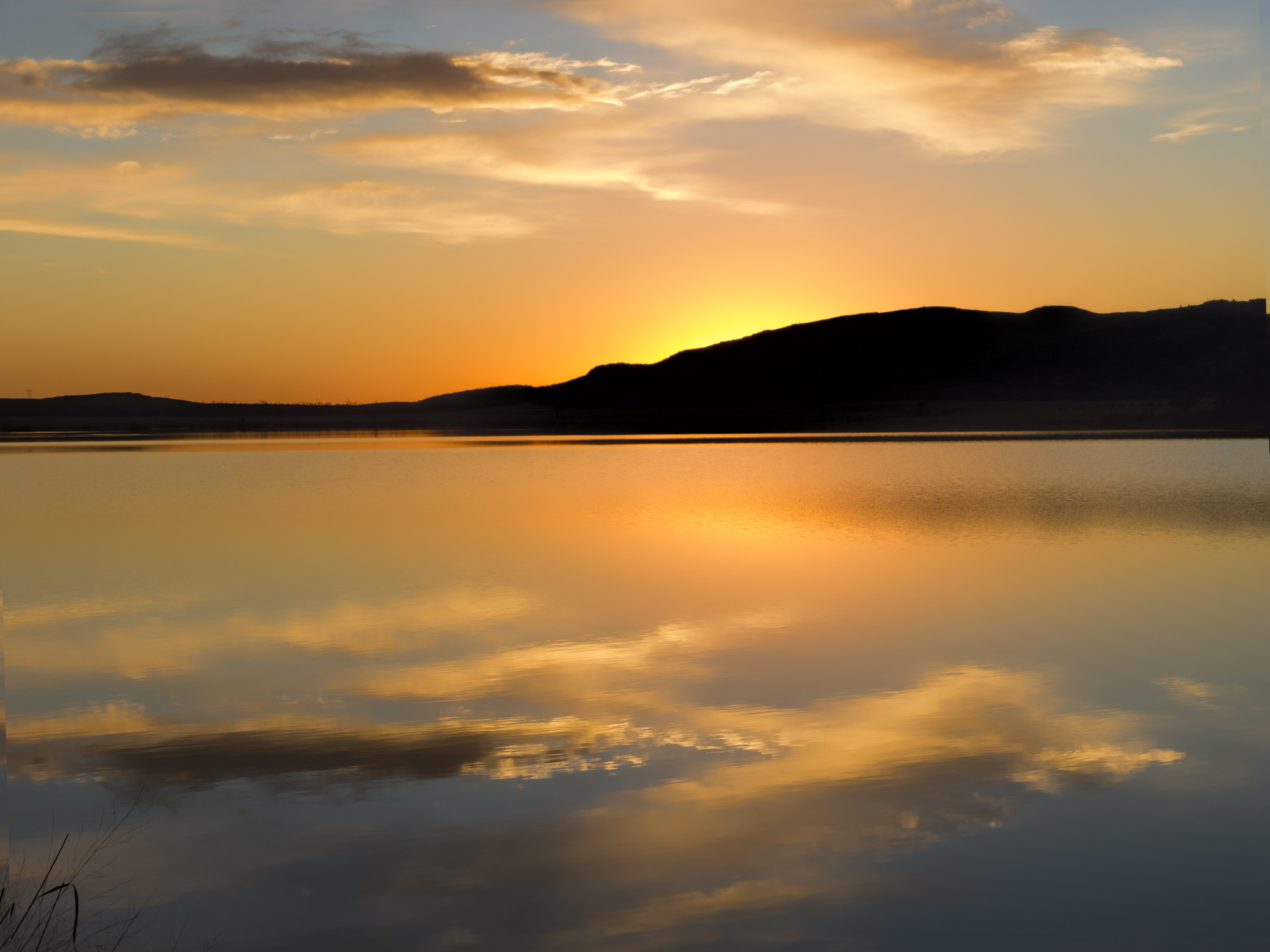Download mobile wallpaper Reflection, Hill, Water, Nature, Sunset, Silhouette for free.