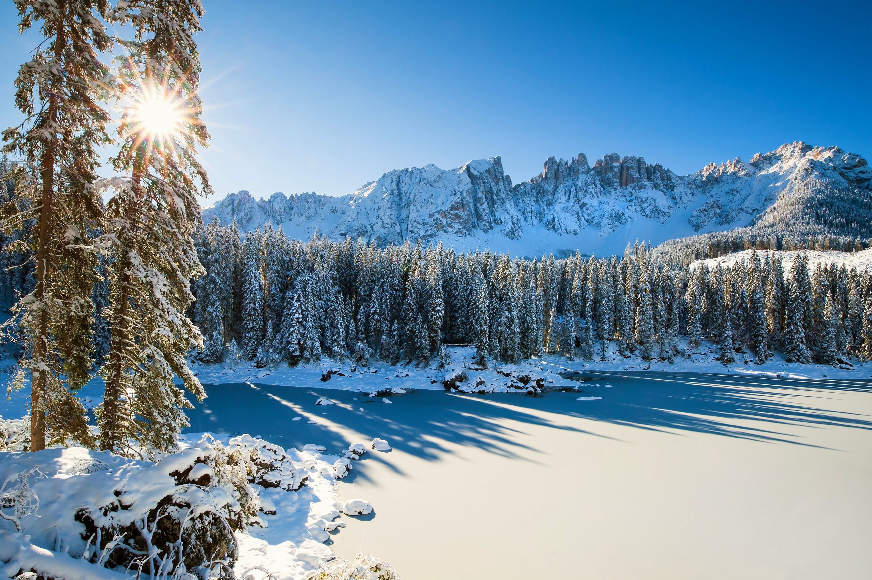 Download mobile wallpaper Winter, Snow, Italy, Mountain, Lake, Forest, Earth, Dolomites, Sunbeam for free.