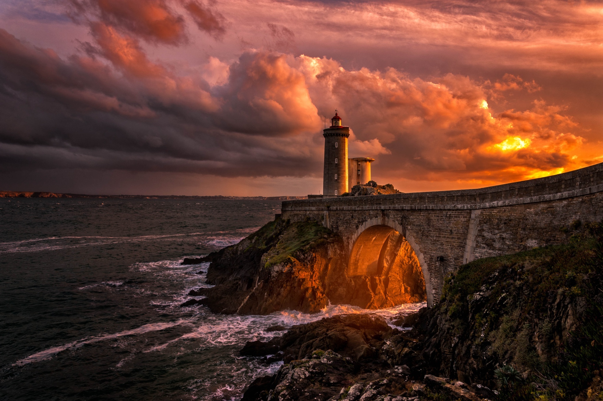 Free download wallpaper Sunset, Sea, Evening, Lighthouse, Arch, Cloud, Man Made on your PC desktop