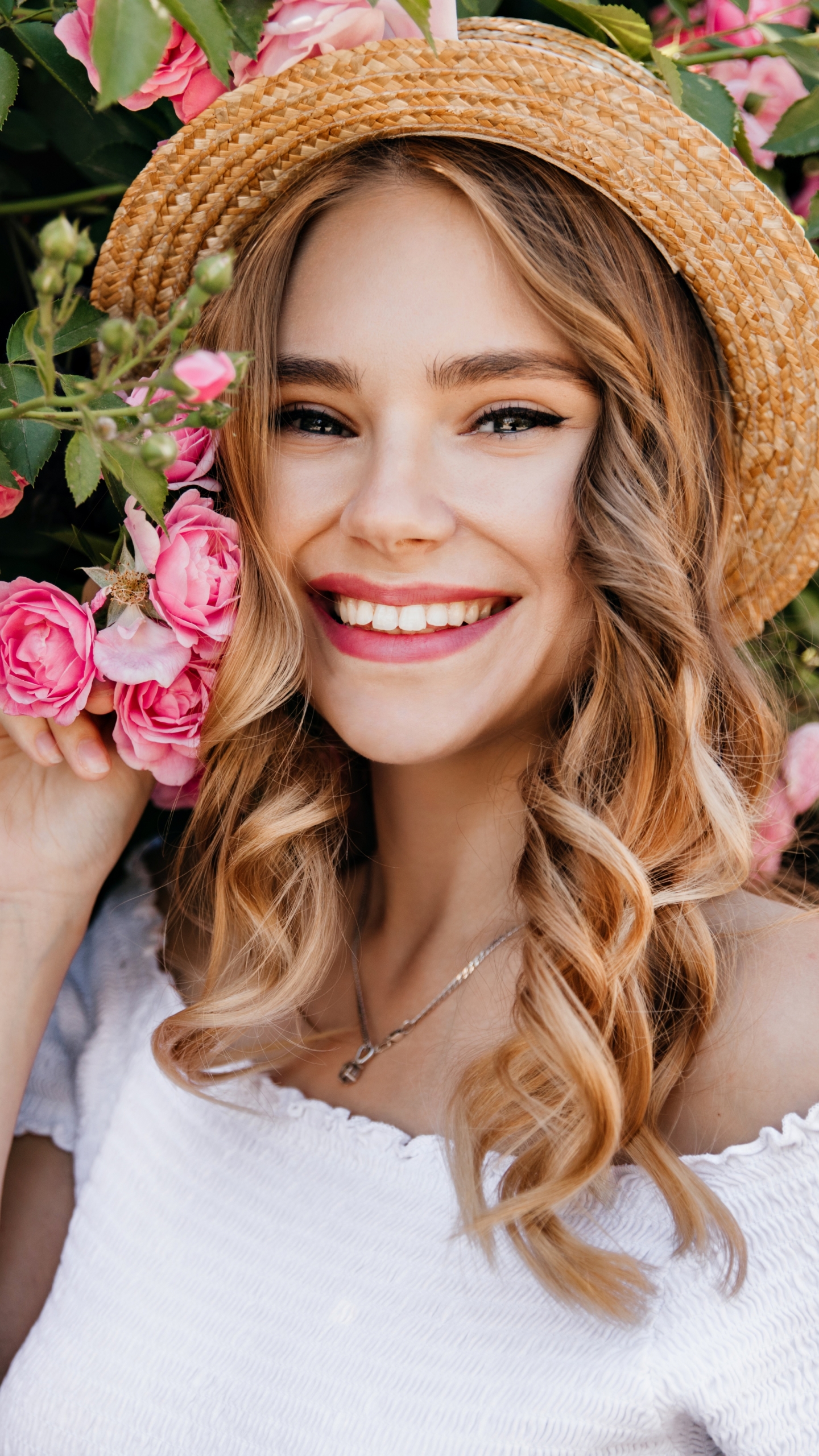 Download mobile wallpaper Smile, Hat, Model, Women, Pink Flower for free.