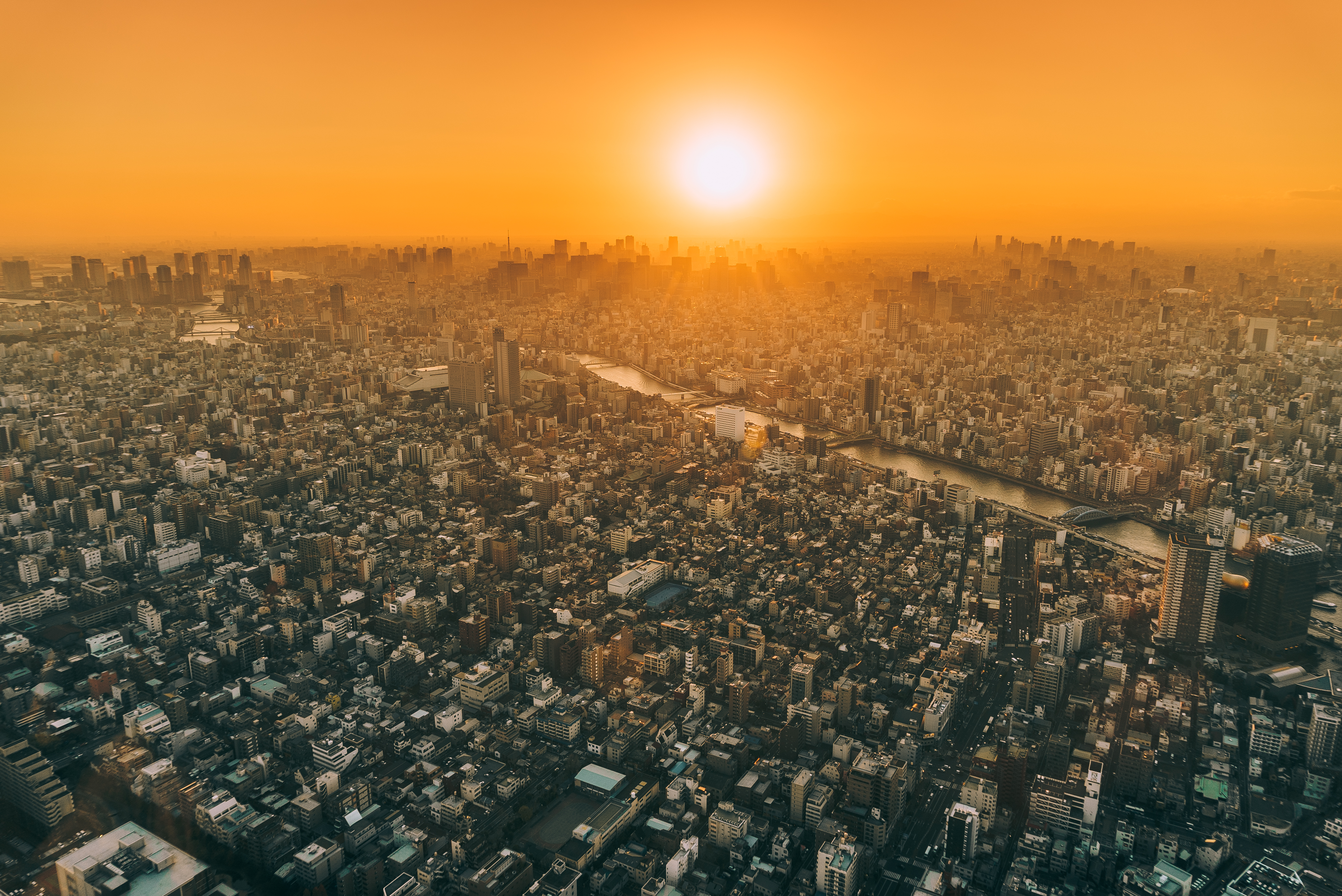 Download mobile wallpaper Cities, City, Skyscraper, Building, Sunrise, Cityscape, Tokyo, Aerial, Sunbeam, Man Made for free.
