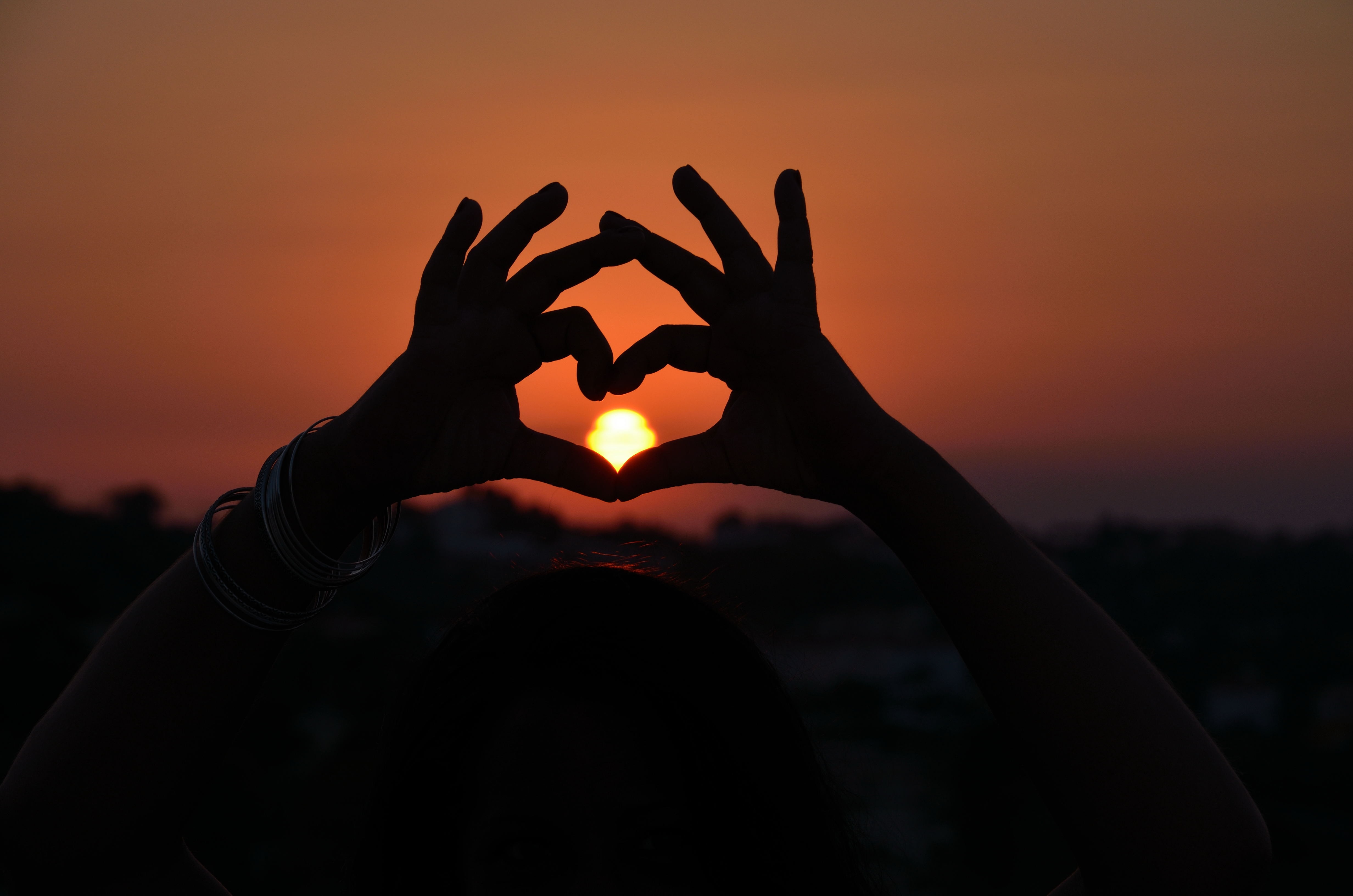 Download mobile wallpaper Sun, Sunset, Hands, Heart, Love for free.