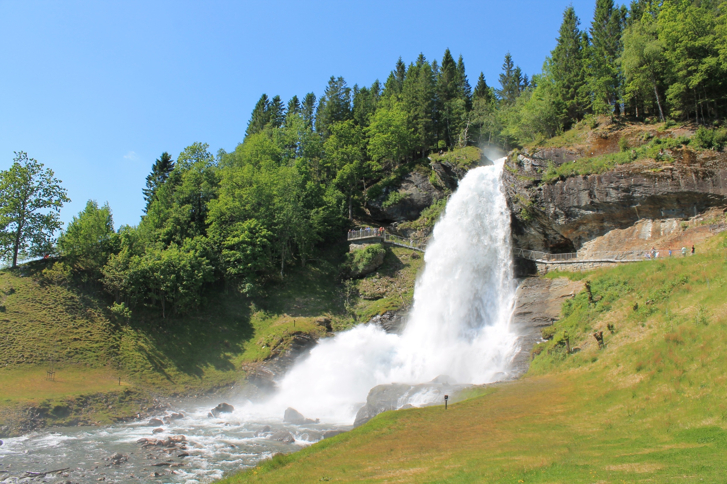 Download mobile wallpaper Waterfalls, Waterfall, Tree, Earth, Bridge, Norway for free.