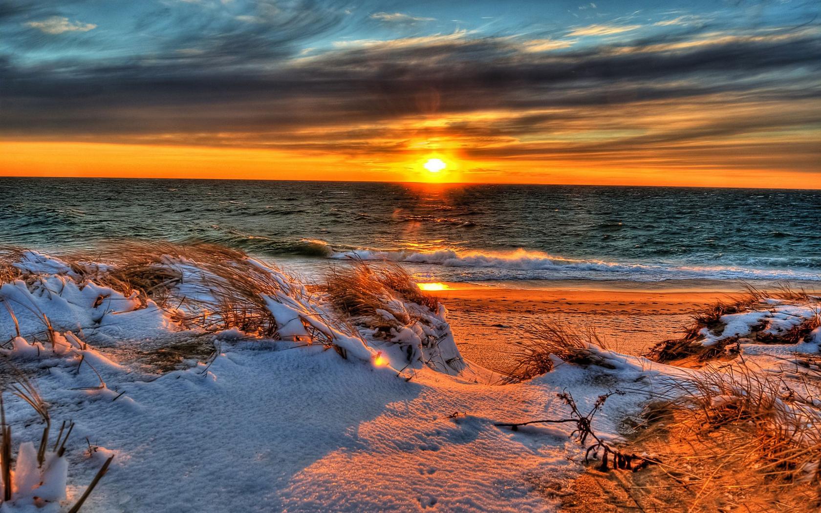 Download mobile wallpaper Winter, Nature, Sunset, Sun, Beach, Snow, Ocean, Earth, Cloud, Wave for free.