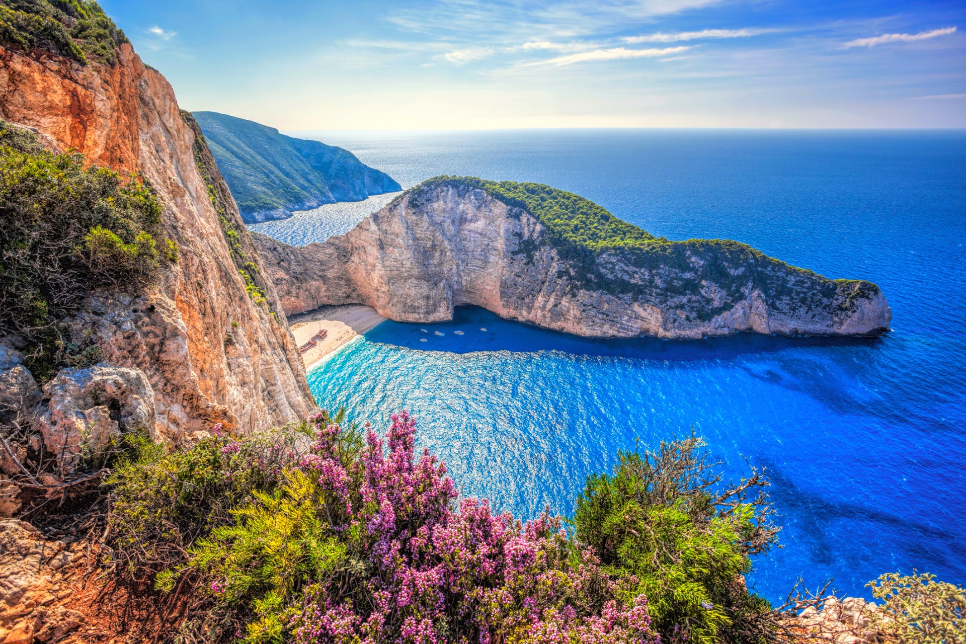Download mobile wallpaper Sea, Beach, Horizon, Flower, Ocean, Earth, Cliff, Greece, Navagio Beach for free.