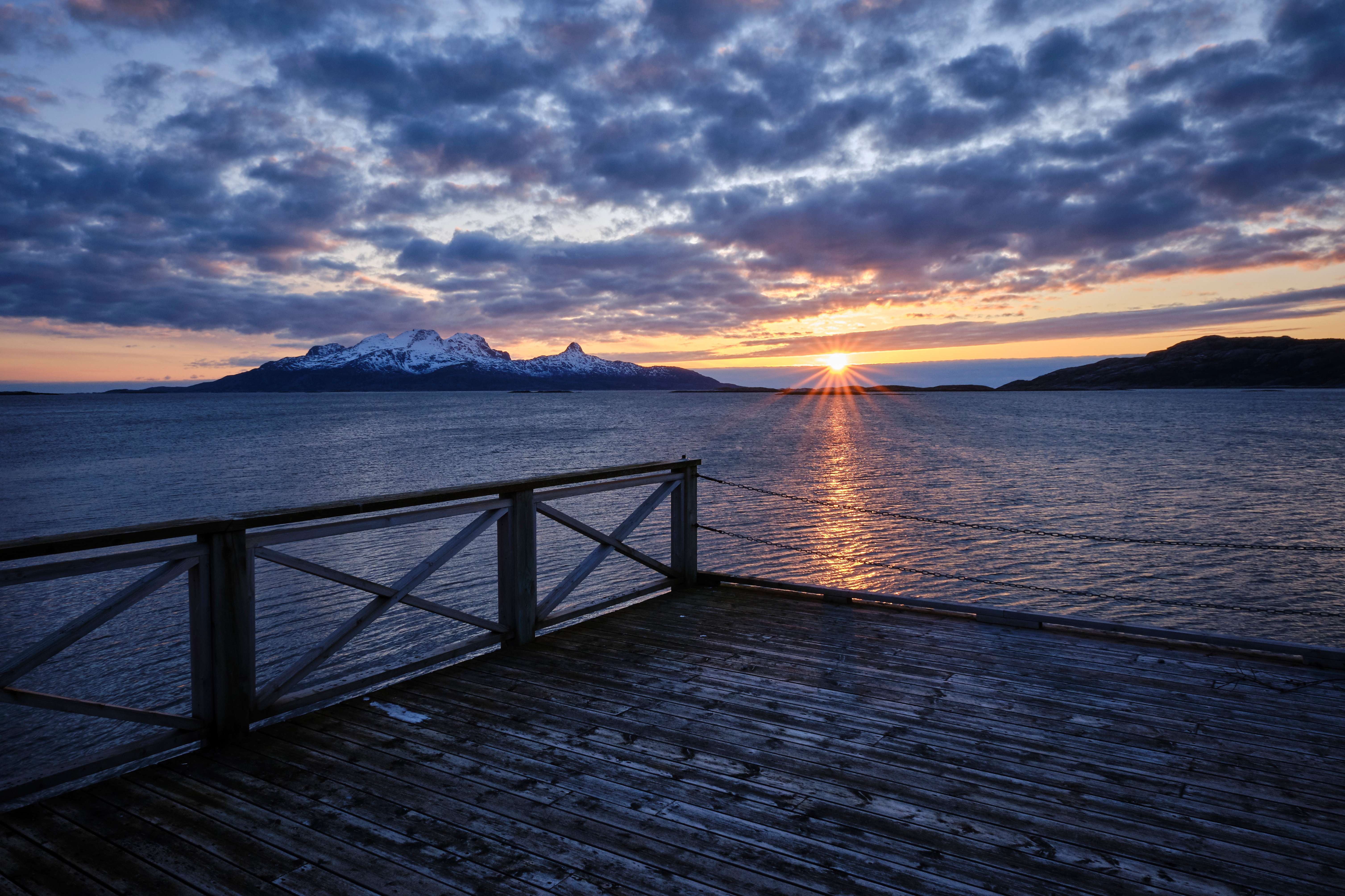 Download mobile wallpaper Sunset, Sea, Mountain, Pier, Norway, Cloud, Man Made for free.
