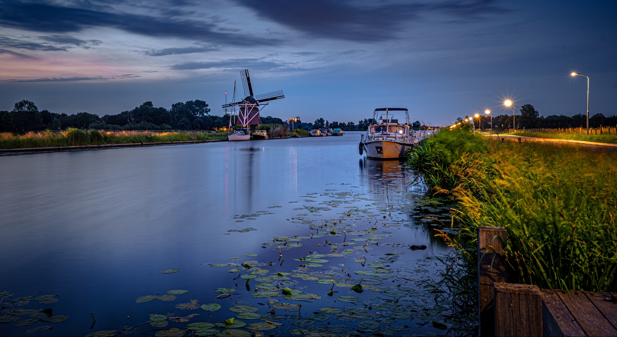 Free download wallpaper Evening, Boat, Netherlands, Windmill, Man Made, Canal on your PC desktop