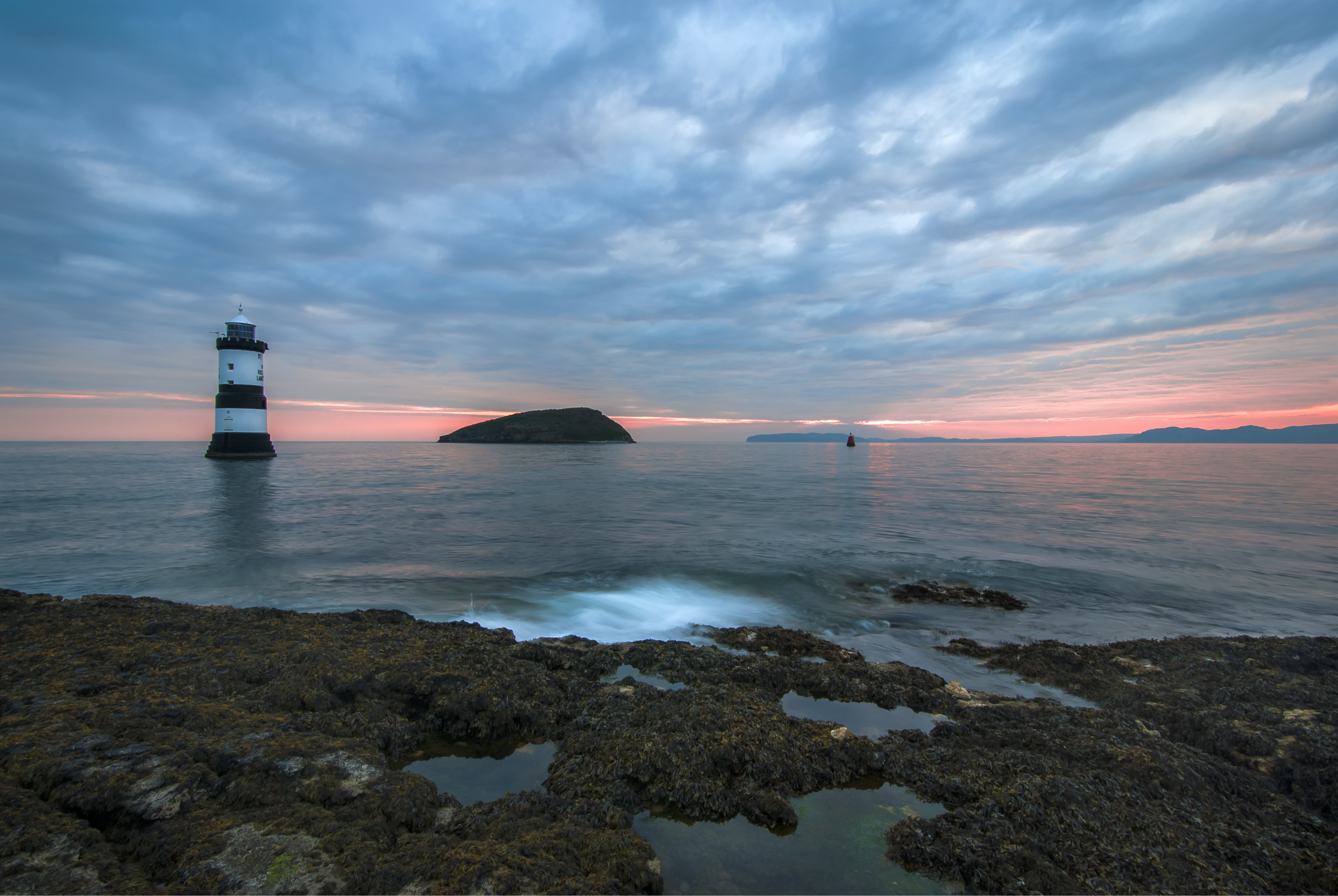 Download mobile wallpaper Sunset, Sky, Sea, Horizon, Ocean, Lighthouse, Cloud, Man Made for free.