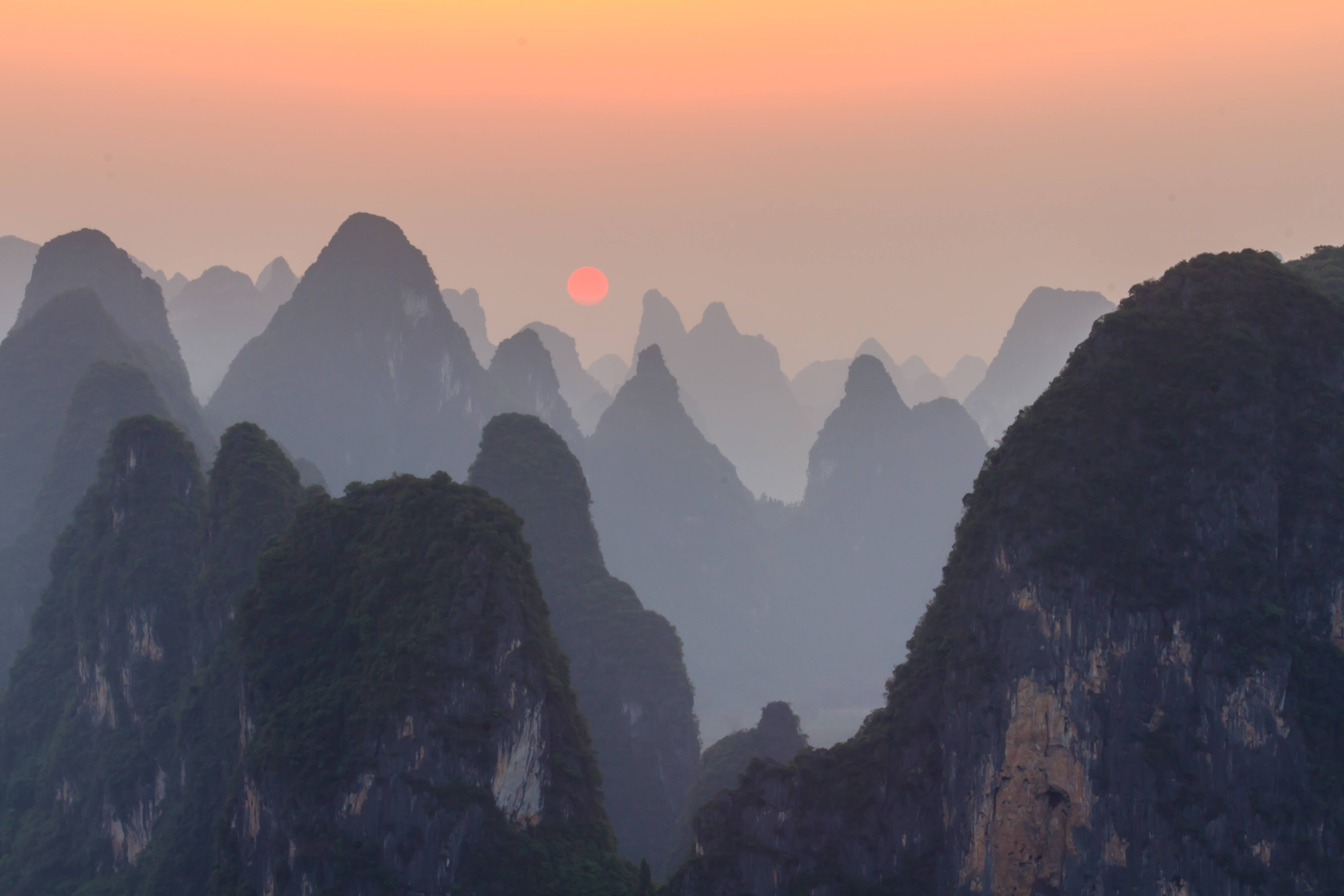Download mobile wallpaper Sunset, Sun, Mountain, Fog, Earth for free.