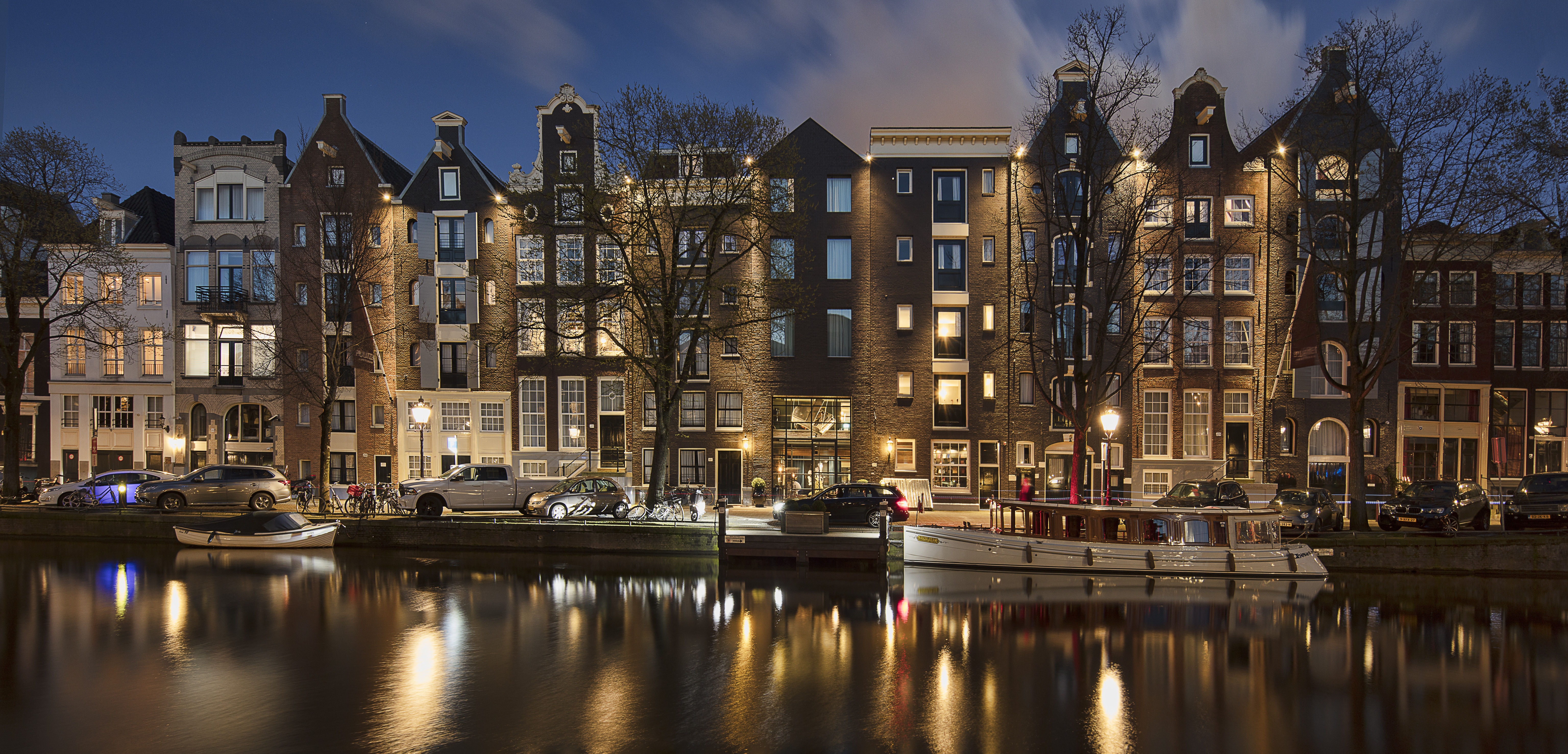 Free download wallpaper Cities, Night, City, Building, Car, Boat, Netherlands, Hotel, Amsterdam, Man Made, Canal on your PC desktop