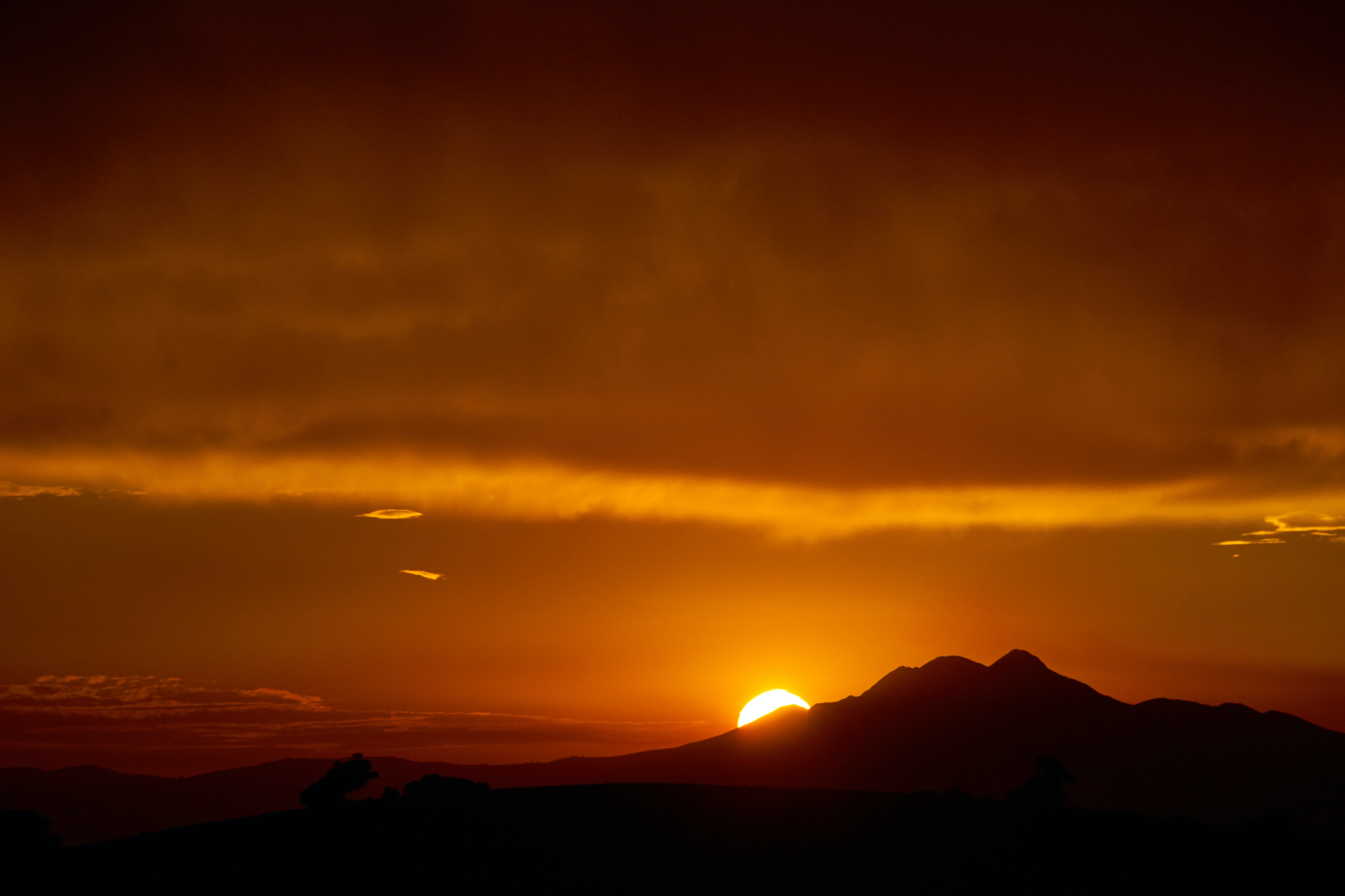 Download mobile wallpaper Mountains, Sun, Sunset, Silhouettes, Dark for free.