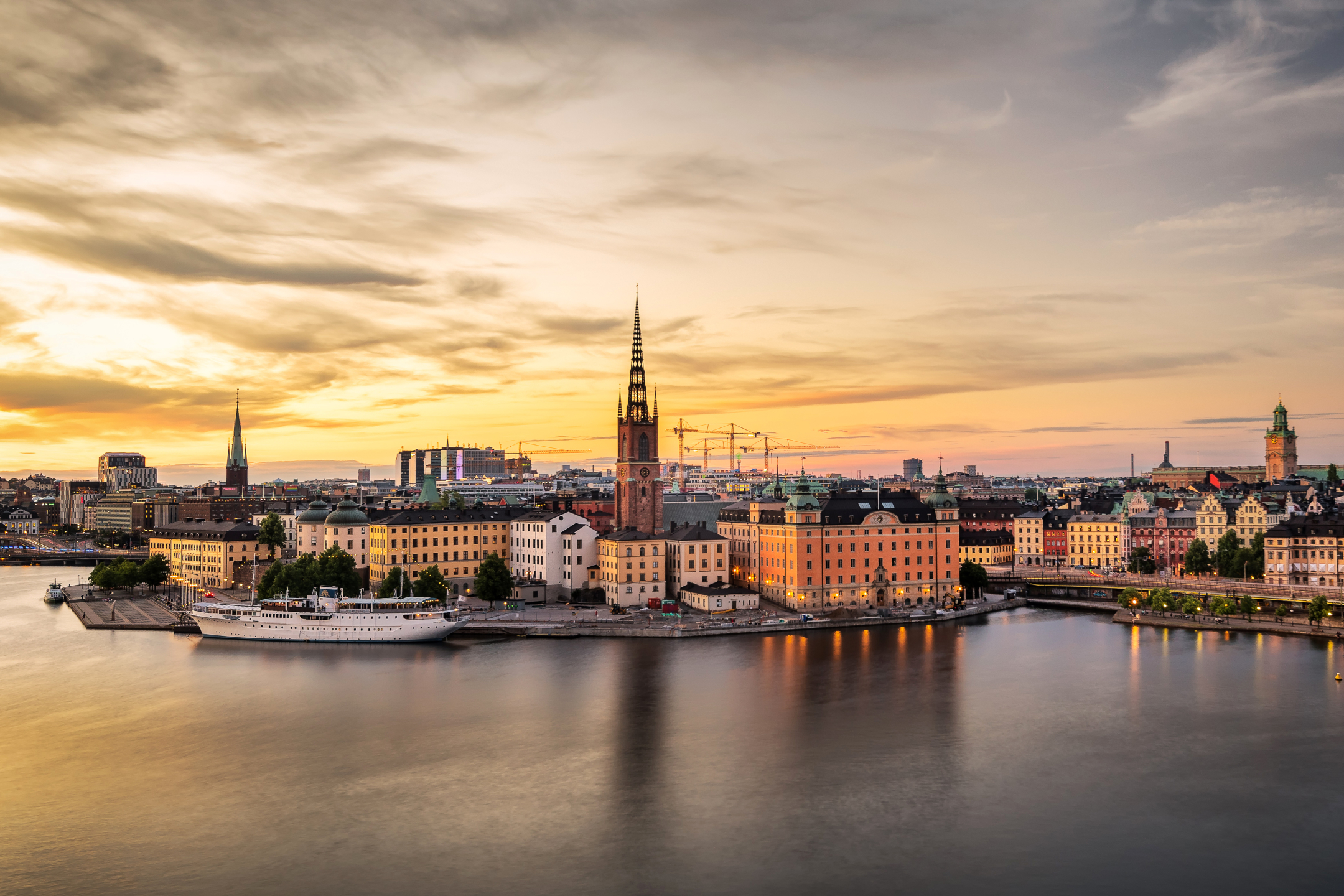 Free download wallpaper Cities, Sunset, City, Evening, Stockholm, Sweden, River, Man Made on your PC desktop