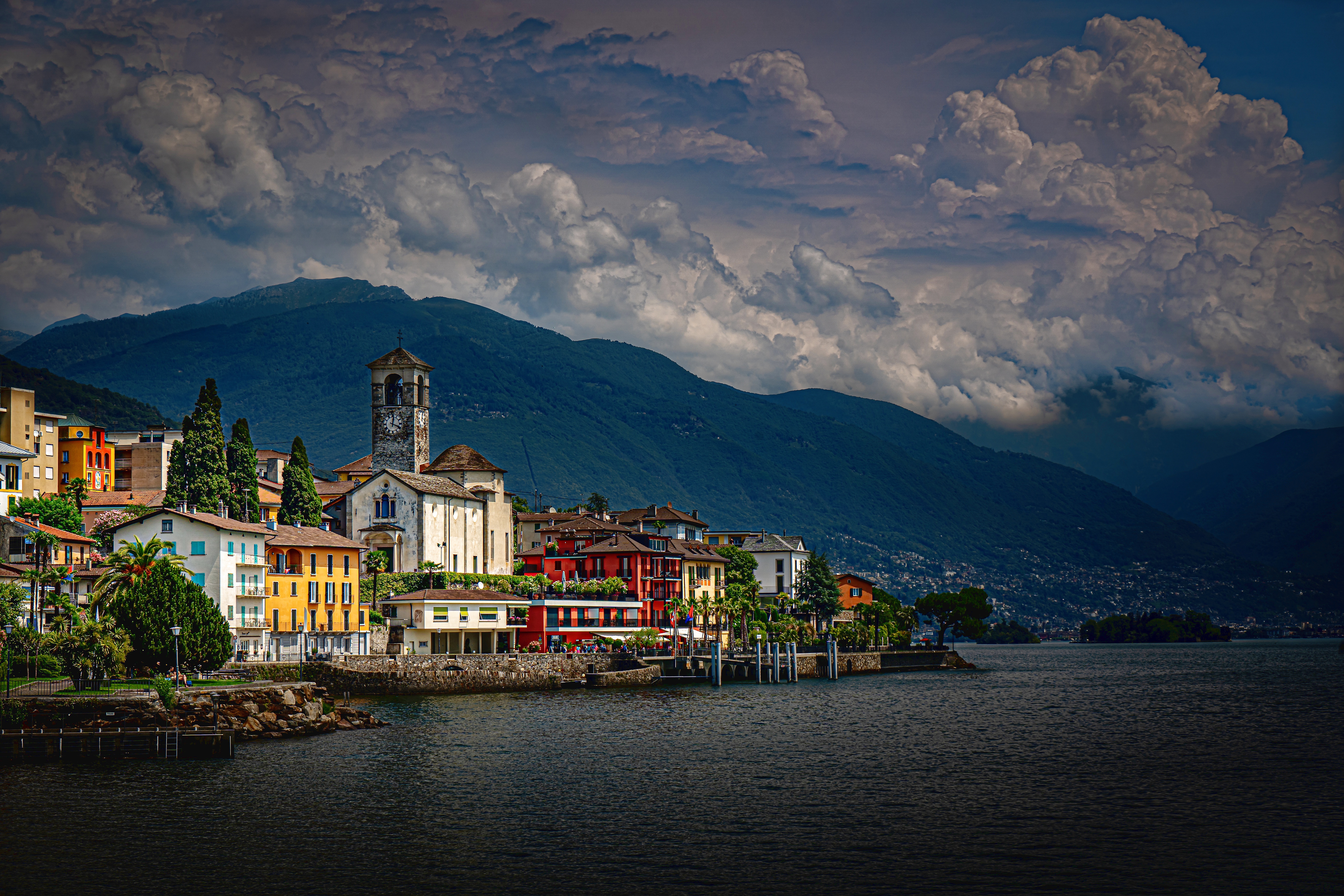 Free download wallpaper Building, Mountain, Lake, House, Alps, Switzerland, Cloud, Church, Town, Man Made, Brissago, Towns on your PC desktop