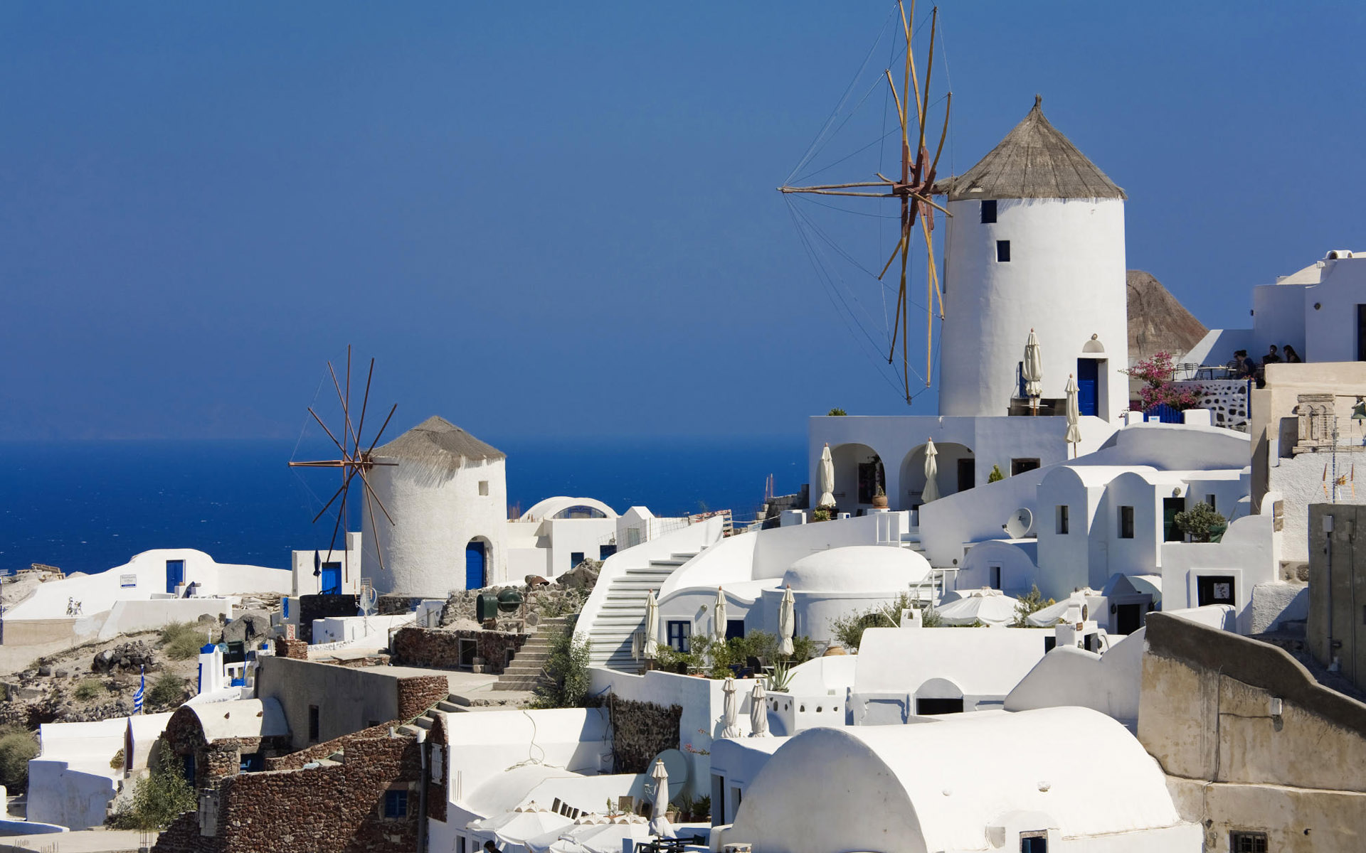 Download mobile wallpaper Village, Greece, Windmill, Santorini, Man Made for free.
