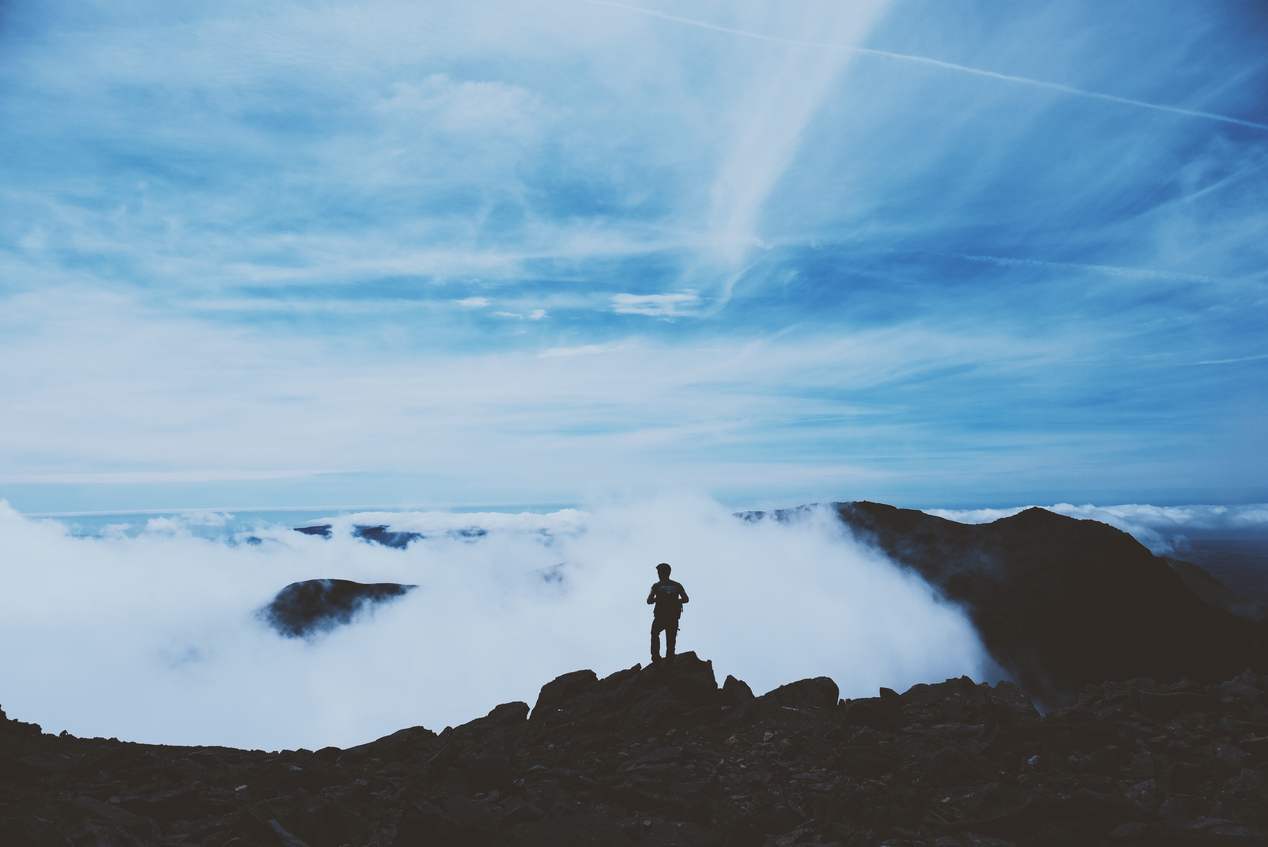 Download mobile wallpaper Top, Vertex, Clouds, Nature, Mountains, Silhouette, Person, Human for free.