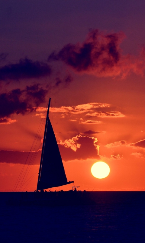 Download mobile wallpaper Sunset, Sky, Sun, Ocean, Colors, Sailboat, Cloud, Sailing, Vehicles, Sailing Ship for free.