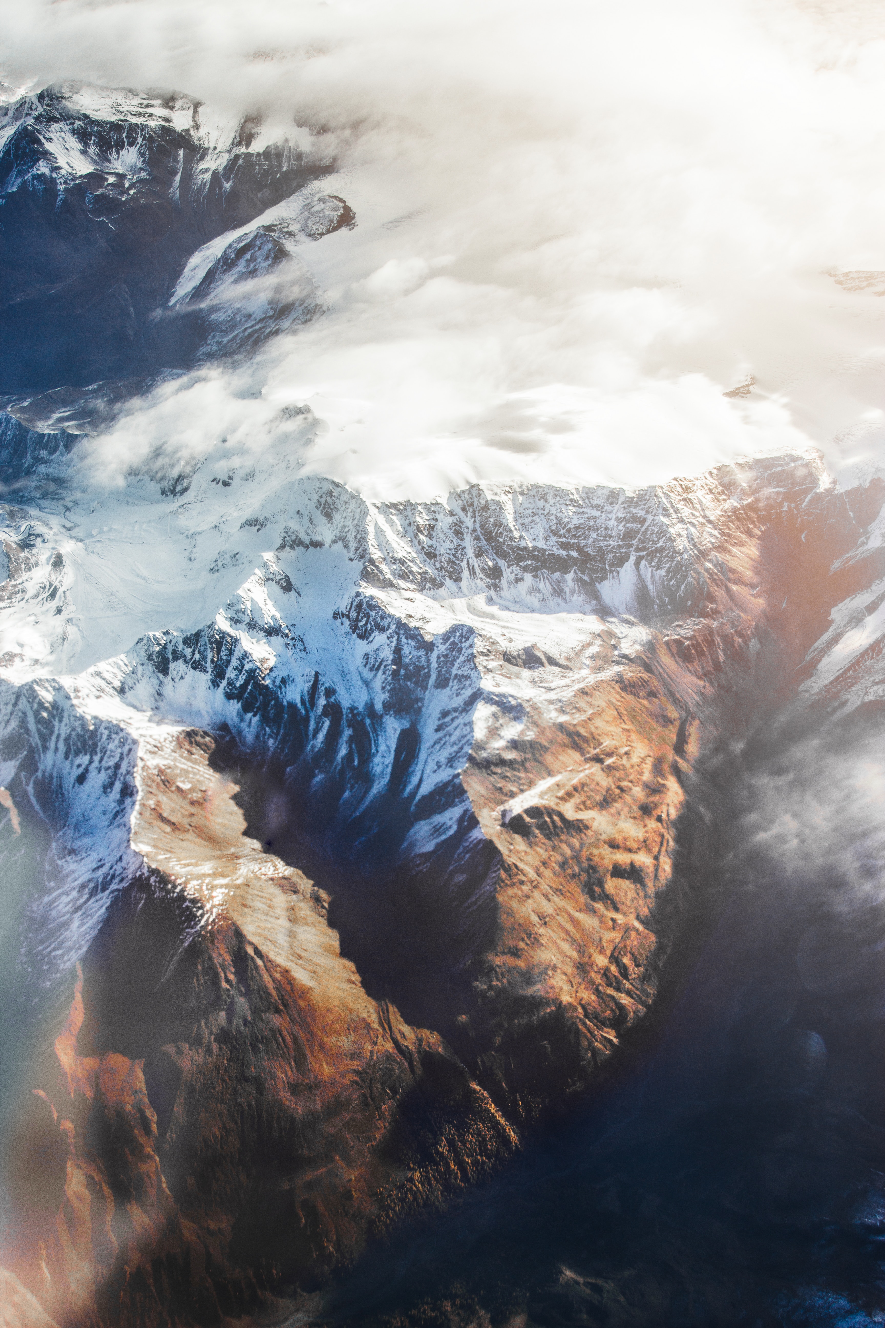 Download mobile wallpaper Snow, Vertex, Tops, Mountains, View From Above, Clouds, Nature for free.