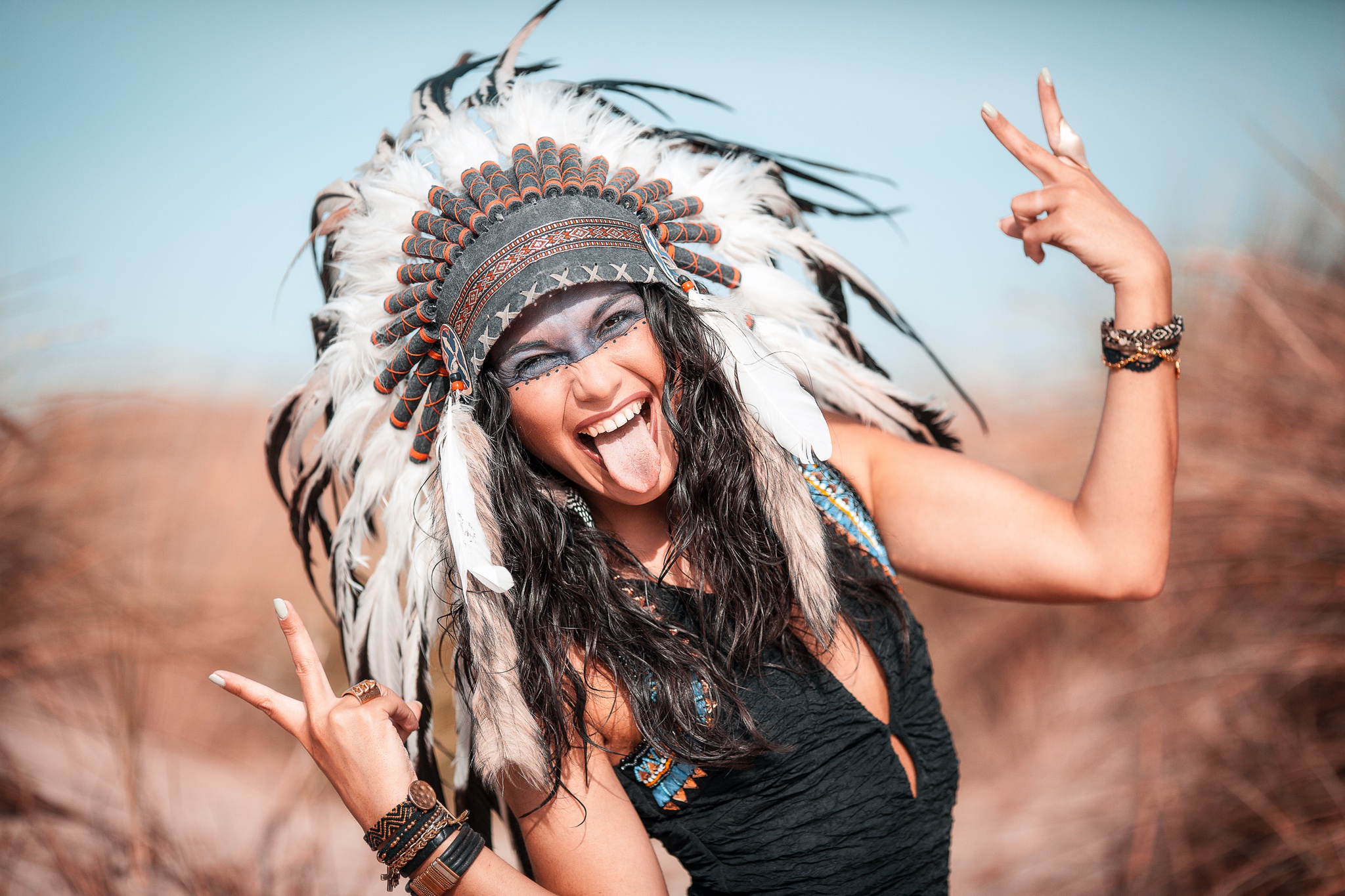 Download mobile wallpaper Feather, Smile, Model, Women, Headdress, Black Hair, Native American, Depth Of Field for free.