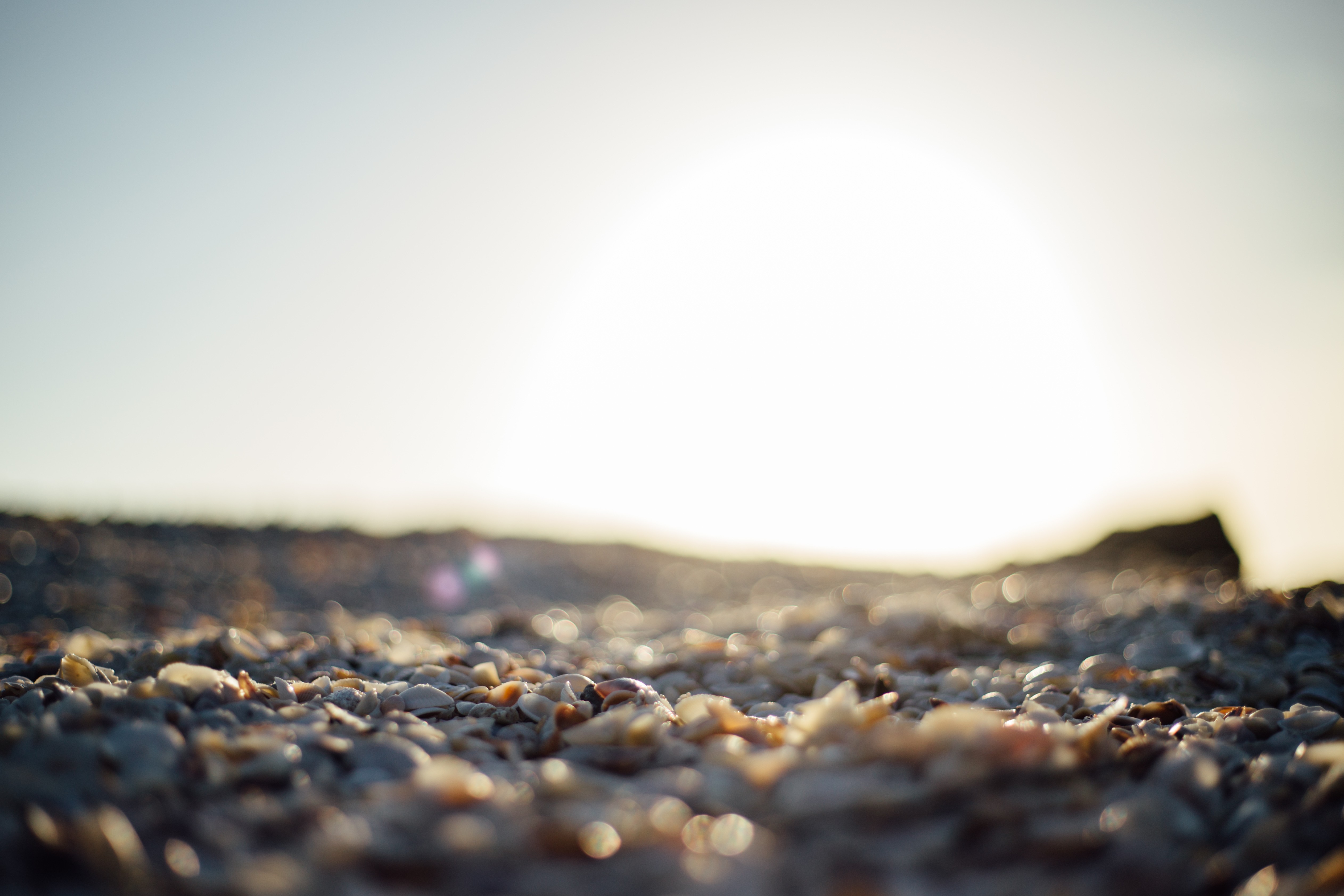 Download mobile wallpaper Sunset, Beach, Earth, Pebbles for free.