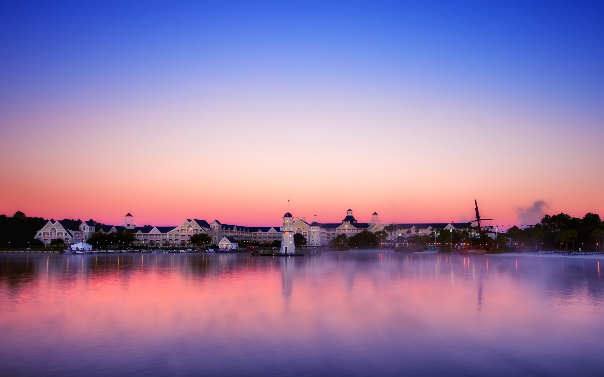 Free download wallpaper Sunset, Reflection, Sunrise, Dusk, Lighthouse, Town, Scenic, Man Made, Towns on your PC desktop