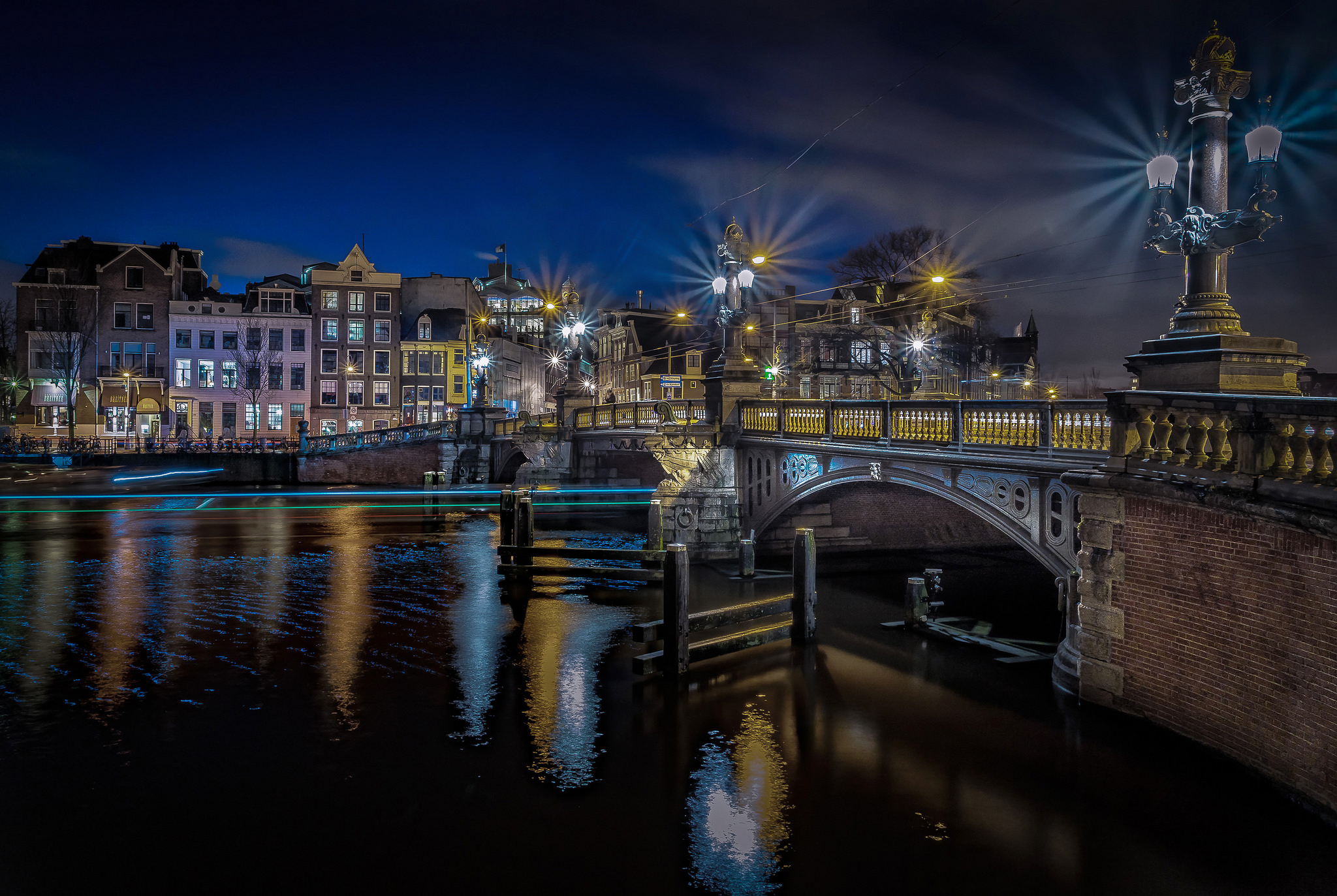Download mobile wallpaper Cities, Night, City, Reflection, Light, Bridge, River, Netherlands, Amsterdam, Man Made for free.