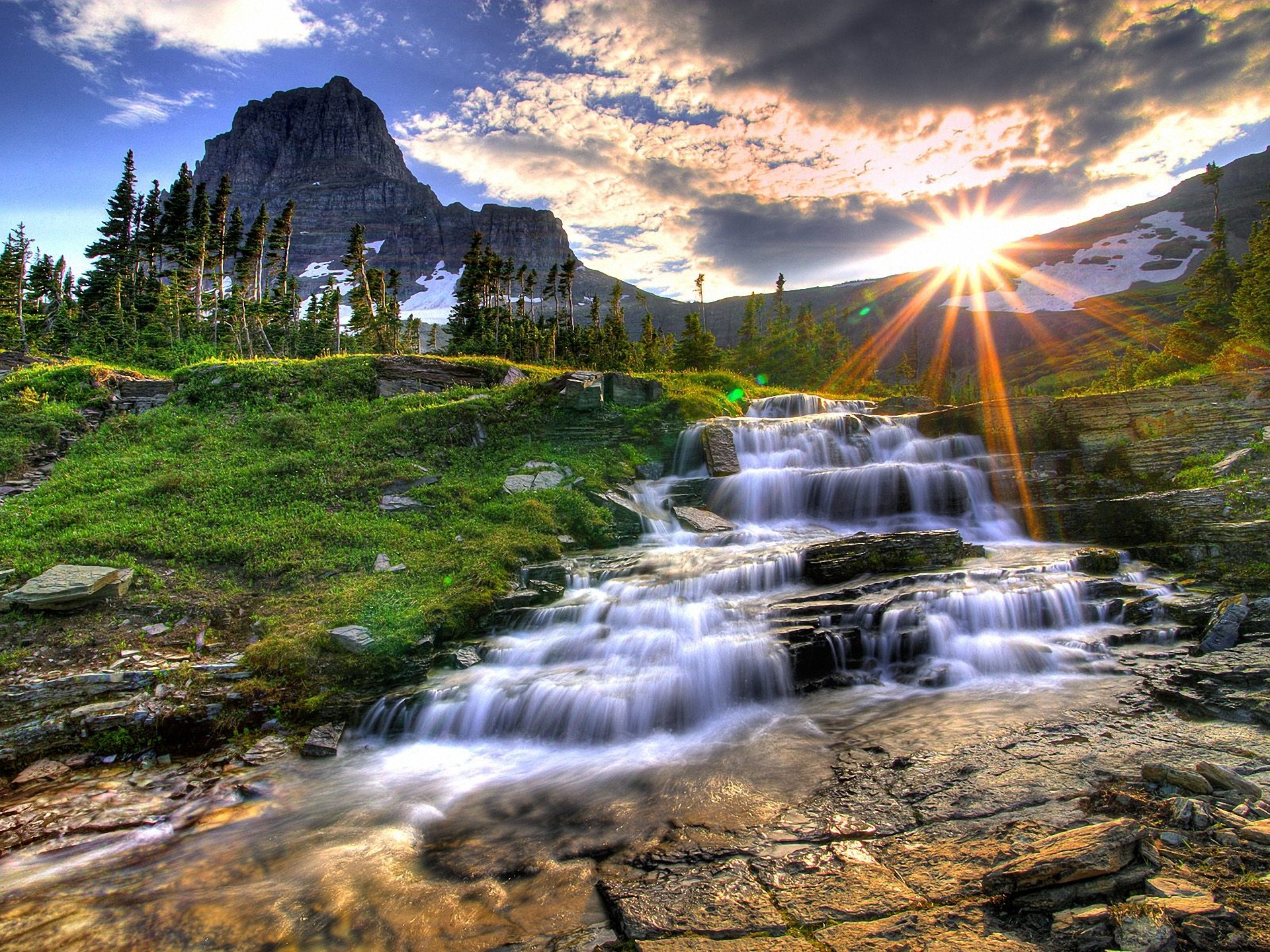 Download mobile wallpaper Nature, Grass, Sun, Mountain, Waterfall, Earth, Stone for free.