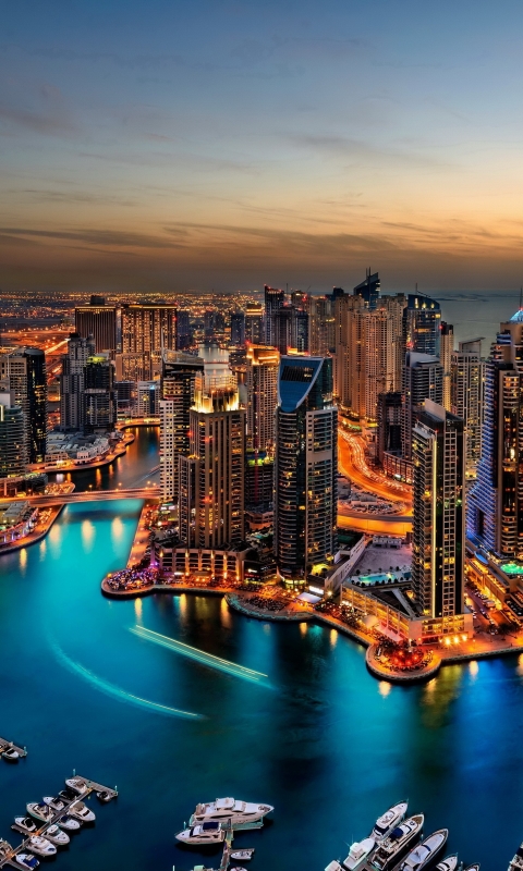 Handy-Wallpaper Städte, Architektur, Stadt, Gebäude, Licht, Dubai, Abend, Boot, Stadtbild, Die Architektur, Menschengemacht, Großstadt kostenlos herunterladen.