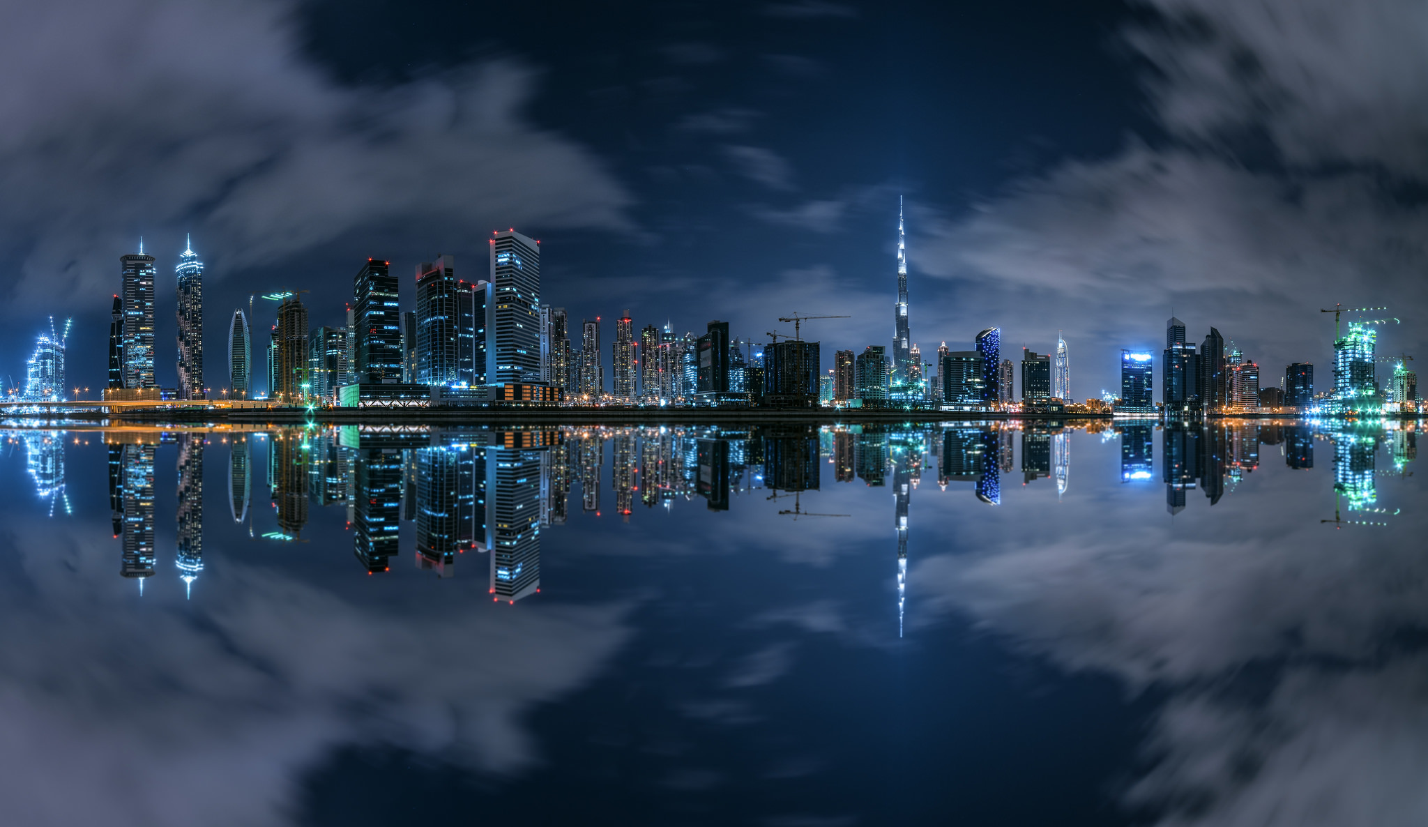 Download mobile wallpaper Cities, Night, City, Skyscraper, Building, Reflection, Dubai, Cloud, United Arab Emirates, Man Made for free.