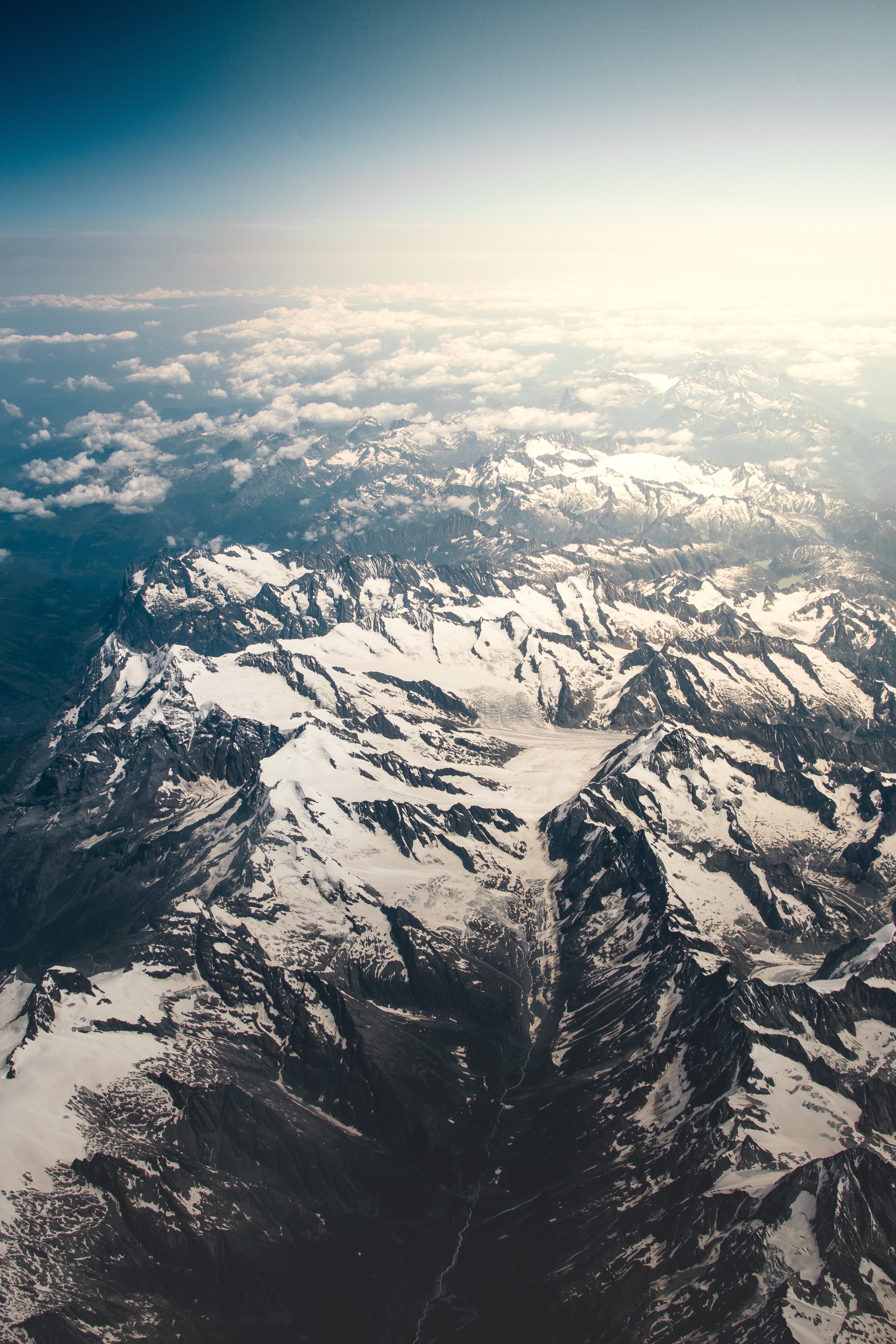 Download mobile wallpaper Vertex, Tops, Clouds, View From Above, Snow Covered, Snowbound, Sky, Mountains, Nature for free.