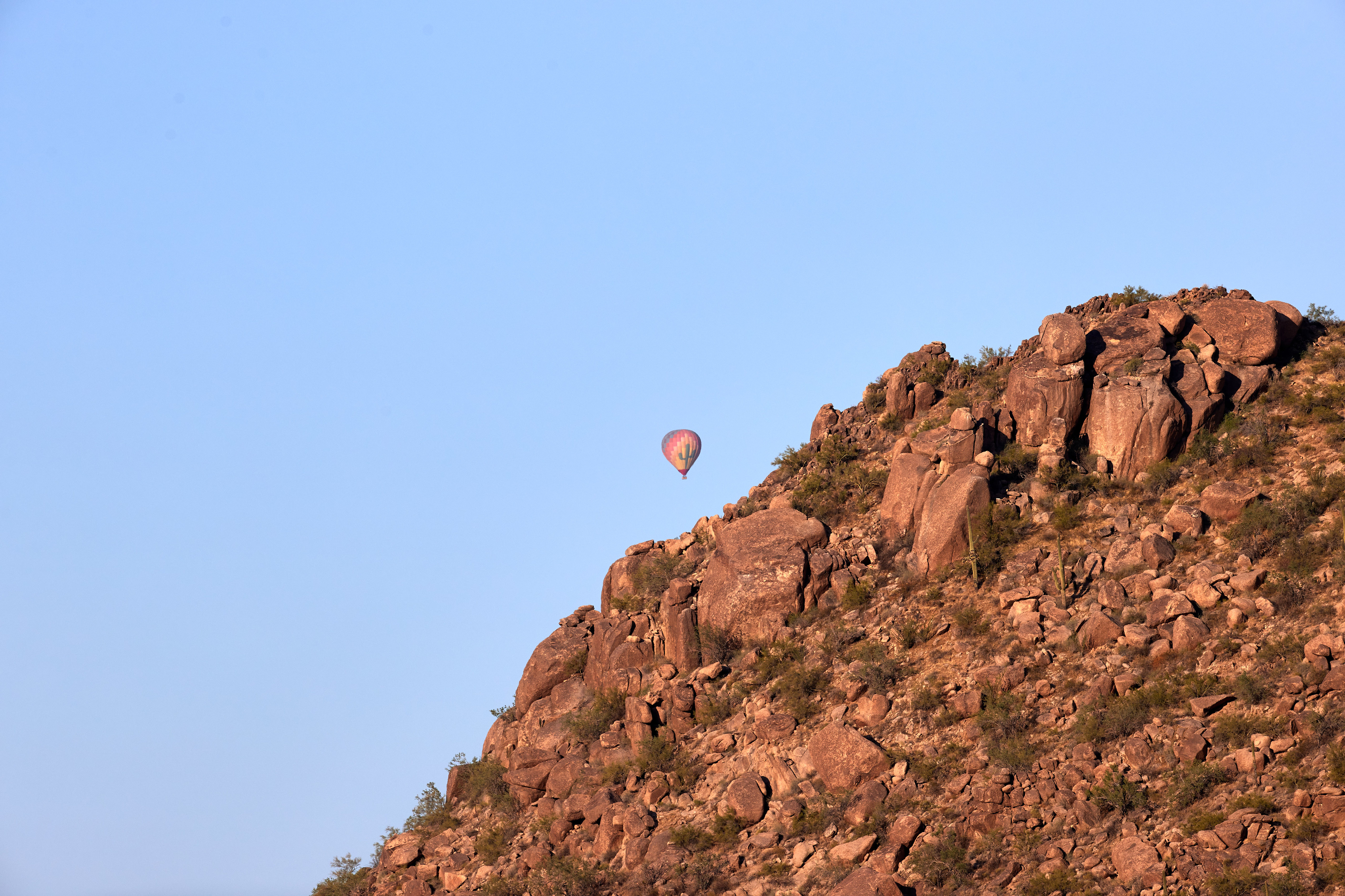 Download mobile wallpaper Sky, Rocks, Nature, Balloon, Mountains for free.