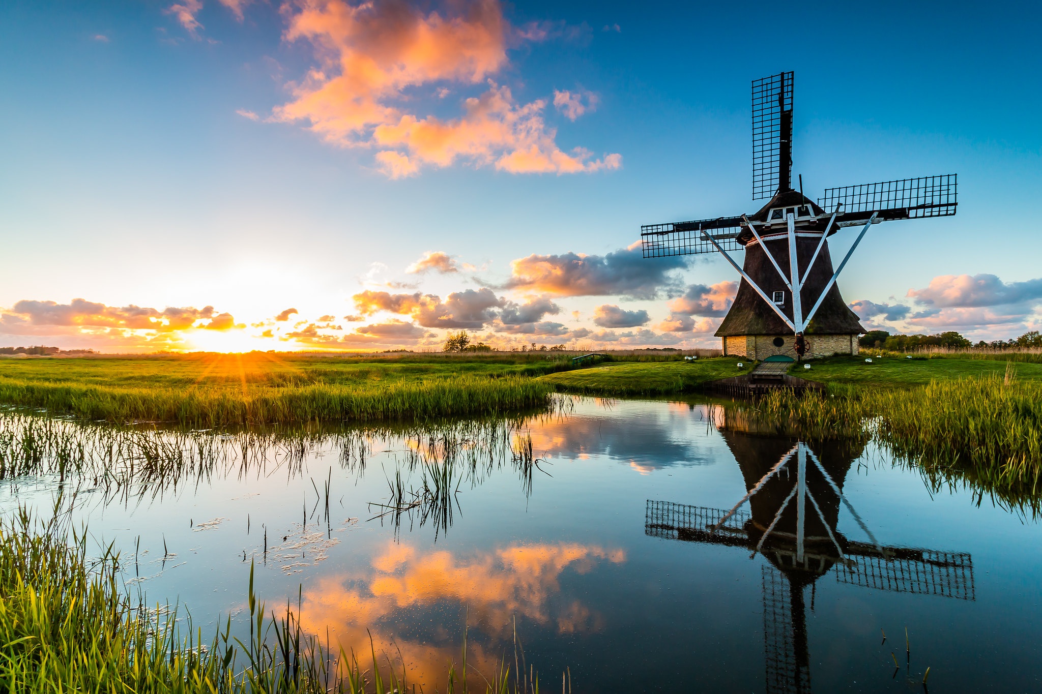 Download mobile wallpaper Sky, Building, Reflection, Sunrise, Windmill, Man Made for free.