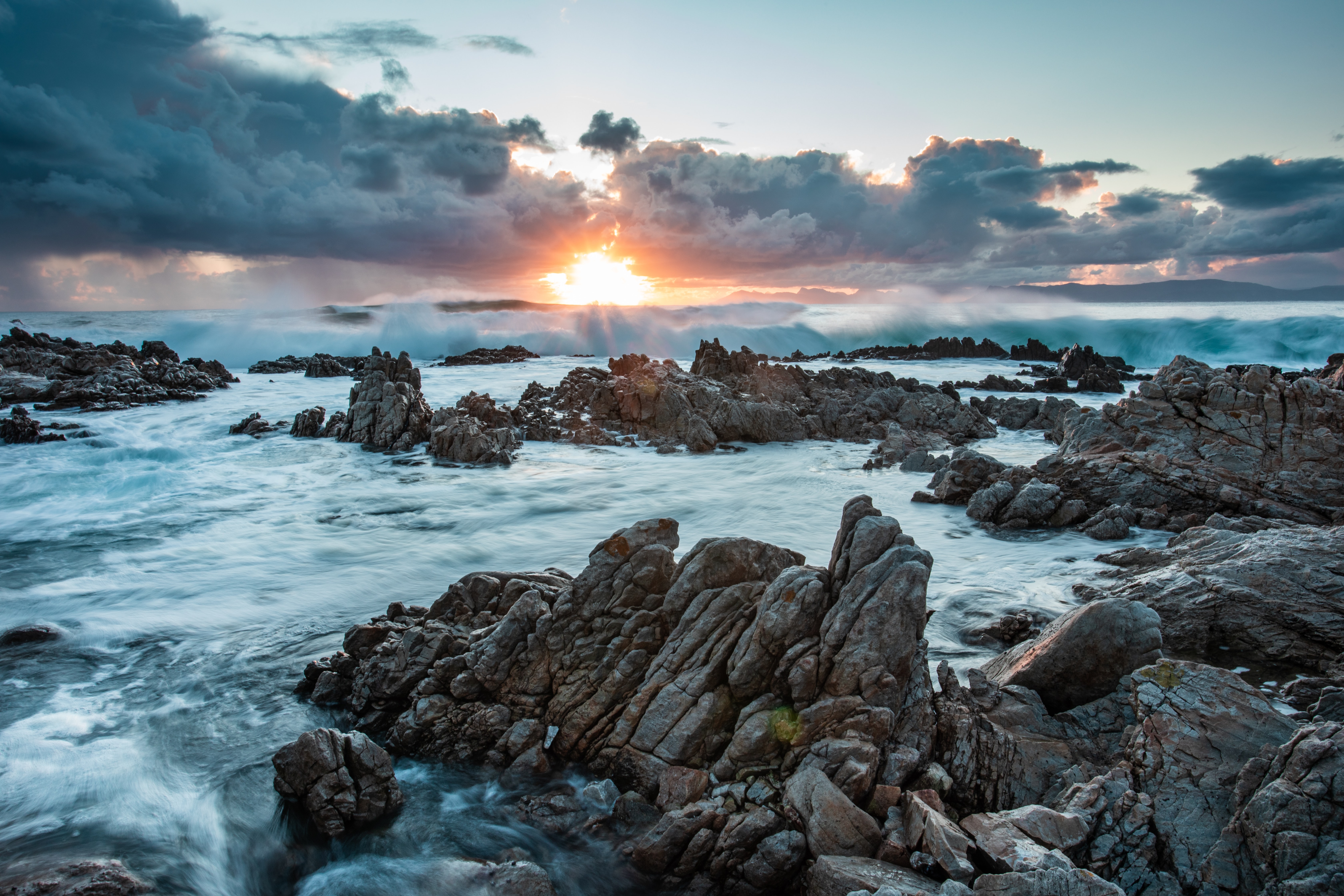 Download mobile wallpaper Clouds, Rocks, Stones, Sunset, Sea, Nature for free.