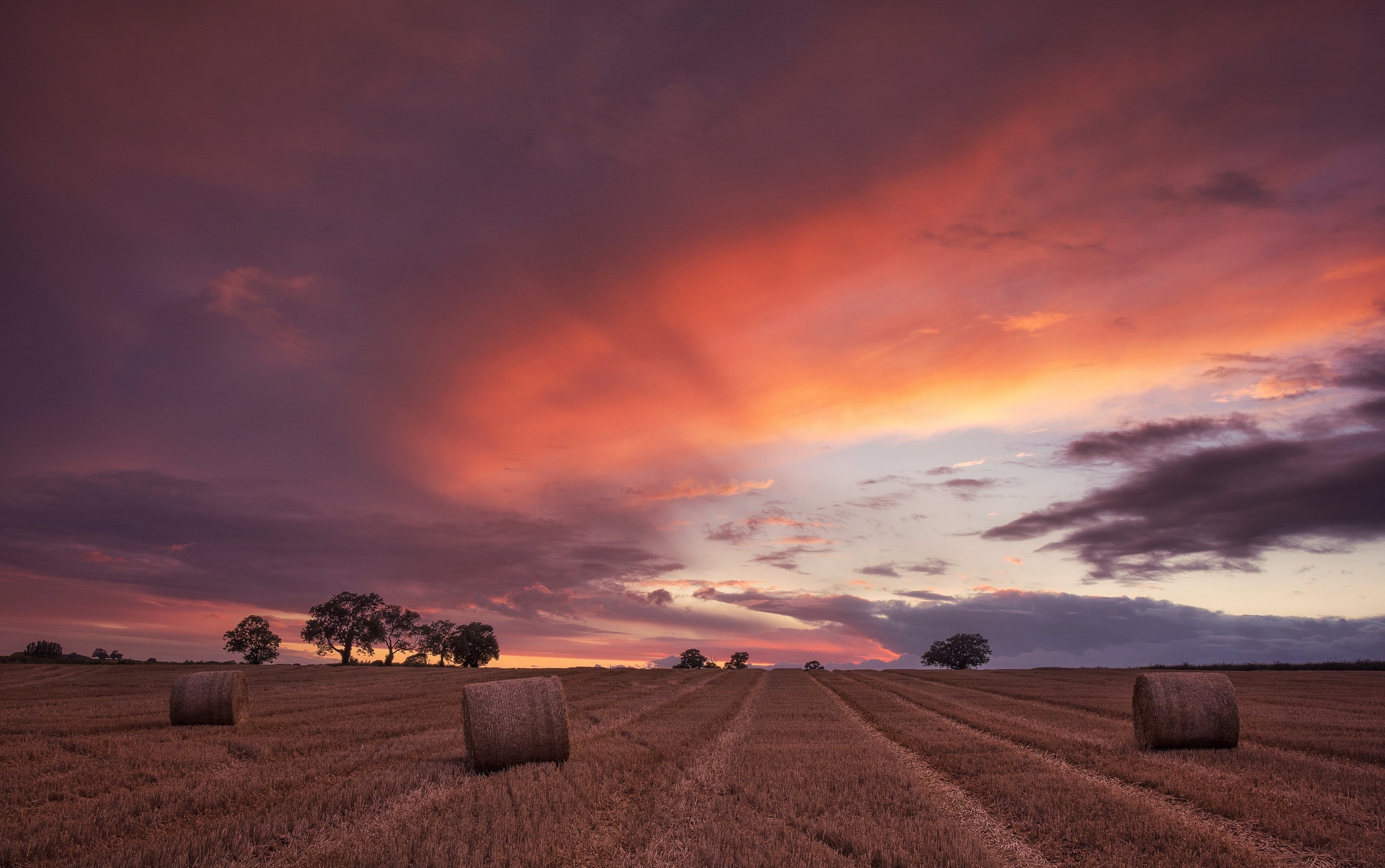 Download mobile wallpaper Nature, Sunset, Sky, Summer, Earth, Field, Cloud, Haystack for free.