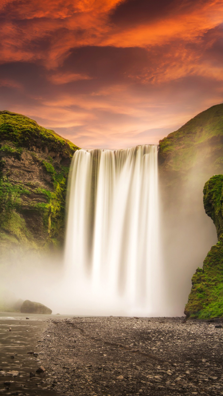 Download mobile wallpaper Sunset, Waterfalls, Waterfall, Earth, Glow, Iceland, Skógafoss, Skógafoss Waterfall for free.