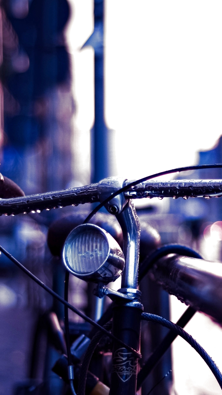 Download mobile wallpaper Rain, City, Bike, Bicycle, Vehicles for free.